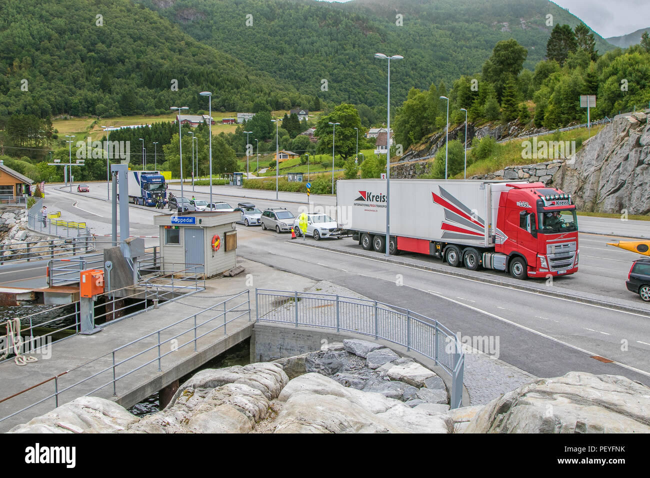Oppedal, Norway, July 23, 2018: Cars and trucks stand in line to board a ferry boat that will bring them across a fjord. Stock Photo