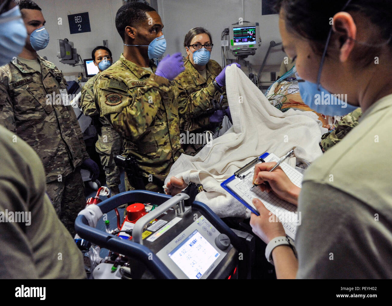 A 455th Expeditionary Medical Group team combines efforts with the Extracorporeal Membrane Oxygenation team to save the life of a NATO ally at the Craig Joint-Theater Hospital at Bagram Air Field, Afghanistan, on Feb. 18, 2016. The ECMO team, dispatched from San Antonio Military Medical Center, uses technology that bypasses the lungs and infuses the blood directly with oxygen, while removing the harmful carbon dioxide from the blood stream. The patient was airlifted to Landstuhl Regional Medical Center, Germany, where he will receive 7 to 14 days of additional ECMO treatment. (U.S. Air Force p Stock Photo