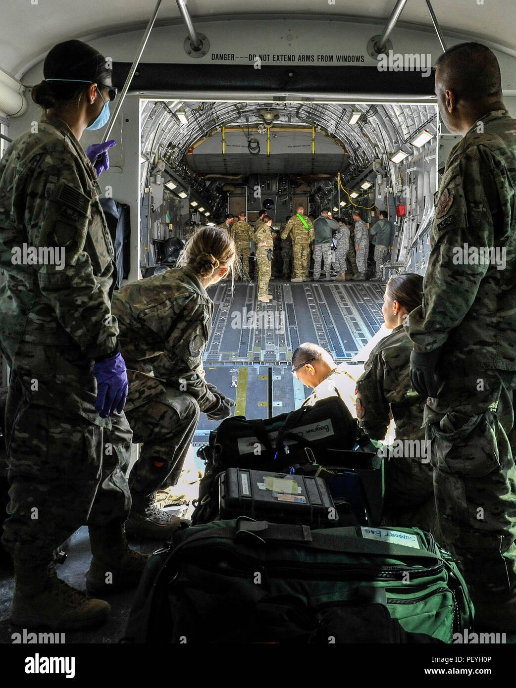 A 455th Expeditionary Medical Group team prepares to load the remaining equipment used to save the life of a NATO ally, who required Extracorporeal Membrane Oxygenation team support, onto an aeromedical evacuation transport at Bagram Air Field, Afghanistan, on Feb. 18, 2016. The ECMO team, dispatched from San Antonio Military Medical Center, uses technology that bypasses the lungs and infuses the blood directly with oxygen, while removing the harmful carbon dioxide from the blood stream. The patient was airlifted to Landstuhl Regional Medical Center, Germany, where he will receive 7 to 14 days Stock Photo