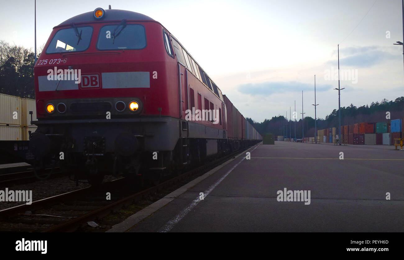 A train loaded with cargo containers full of ammunition pulls into the ...