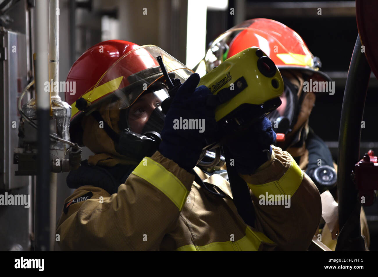 Cross Main Firefighting Logistics Specialist 2nd Class uses a naval firefighting thermal imager ...
