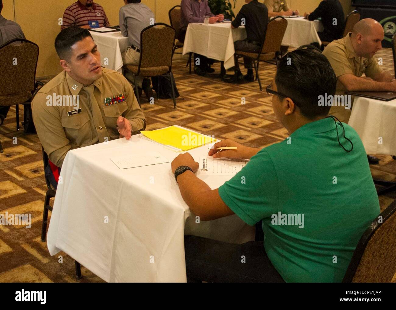 Captain Juan Chavez speaks to a student about different career opportunities available in the Marine Corps during the Mexican American Engineers and Scientists reverse career fair at the DoubleTree by Hilton Hotel in San Antonio, Feb. 18, 2016. Chavez currently serves as a Recruiting Support Officer at Recruiting Station Albuquerque. Partnering with influential Latino organizations like MAES provides the Marine Corps with the ability to build relationships with influential community leaders and transform them into brand ambassadors of the Marine Corps. Stock Photo