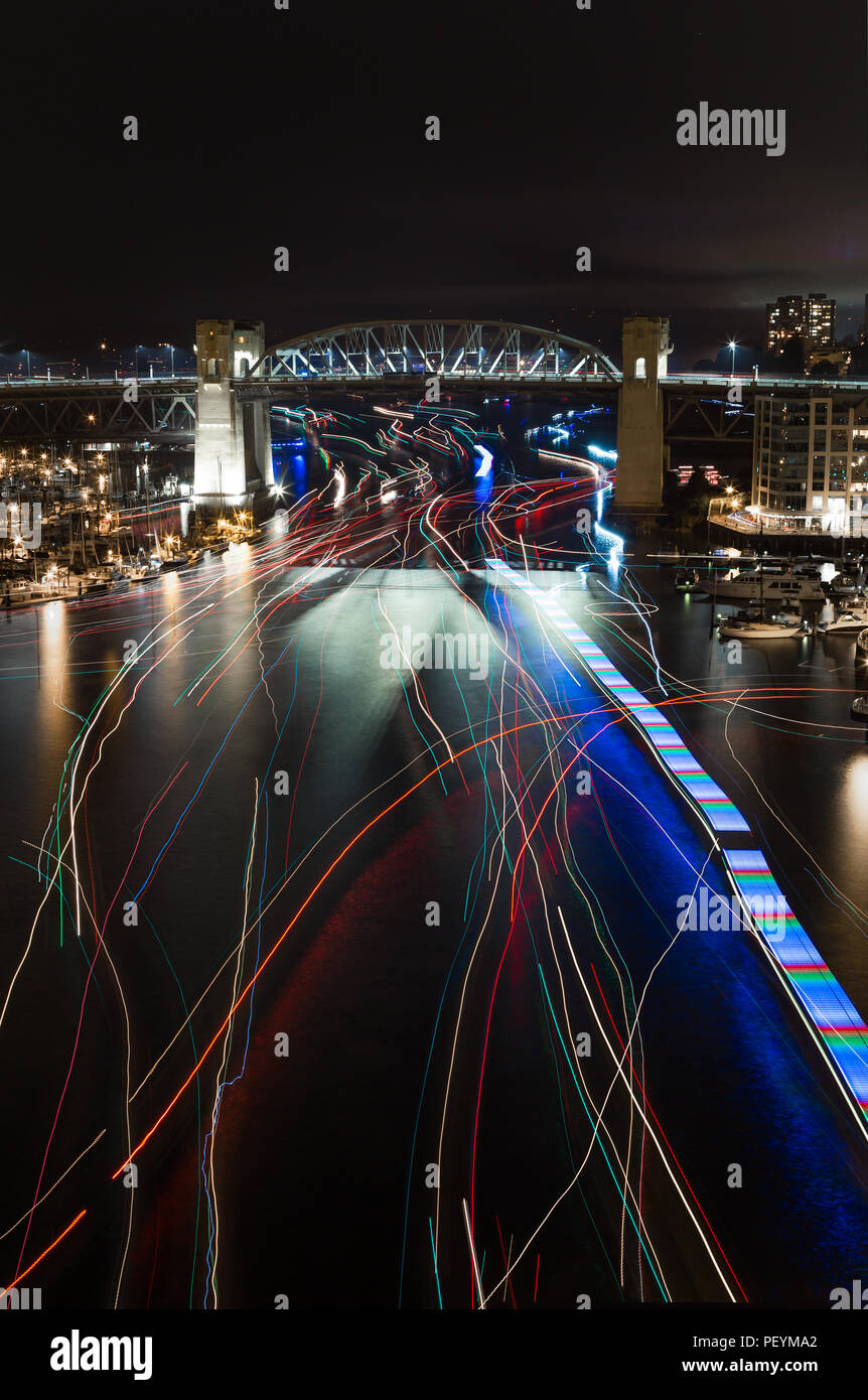 Light trails from boats near English Bay, Vancouver, returning from thae fireworks display, Celebration of Light. Stock Photo