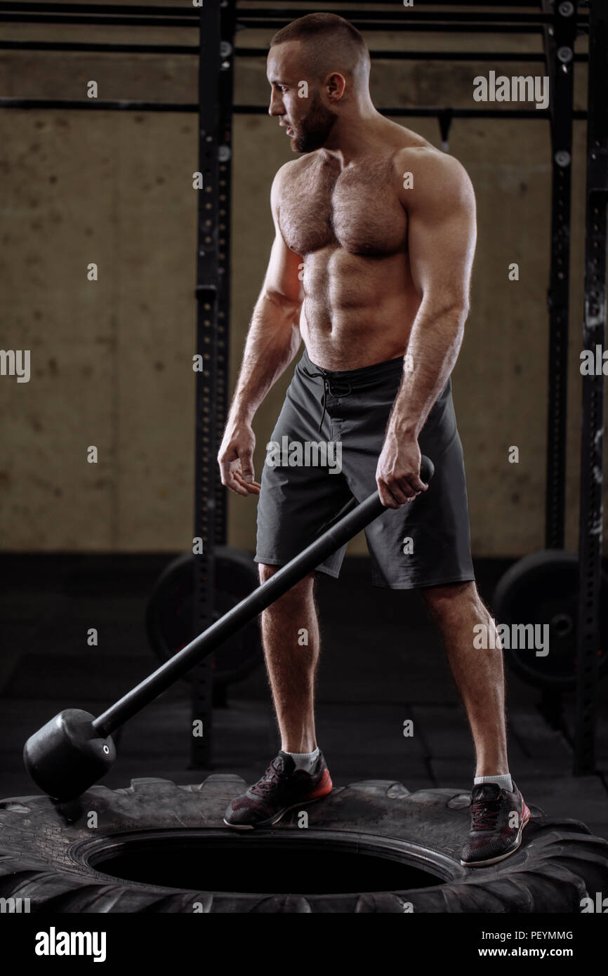 Crossfit Sledge Hammer Man Workout High Resolution Stock Photography