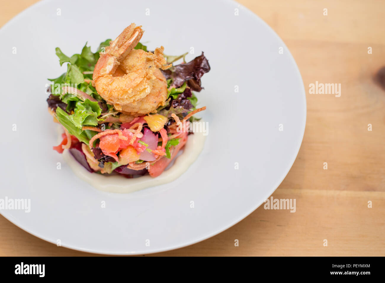 A prawn salad with beets on a white plate. Stock Photo