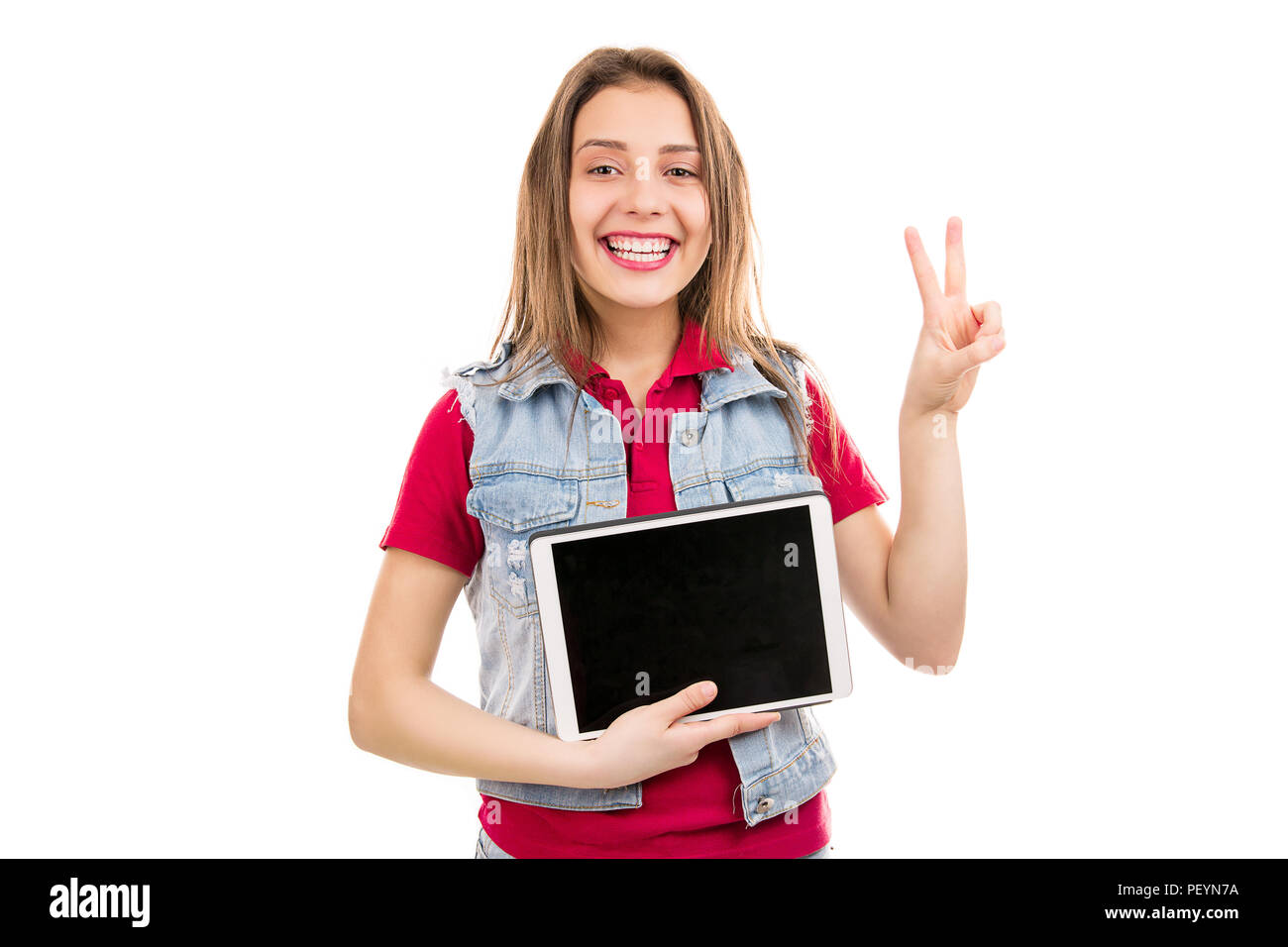 Stylish young woman showing two fingers while demonstrating modern tablet isolated on white background Stock Photo