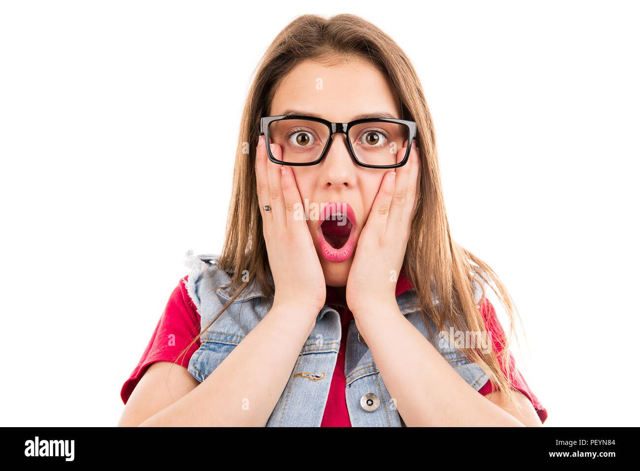 Pretty woman in glasses holding hands on cheeks and looking at camera isolated on white background Stock Photo