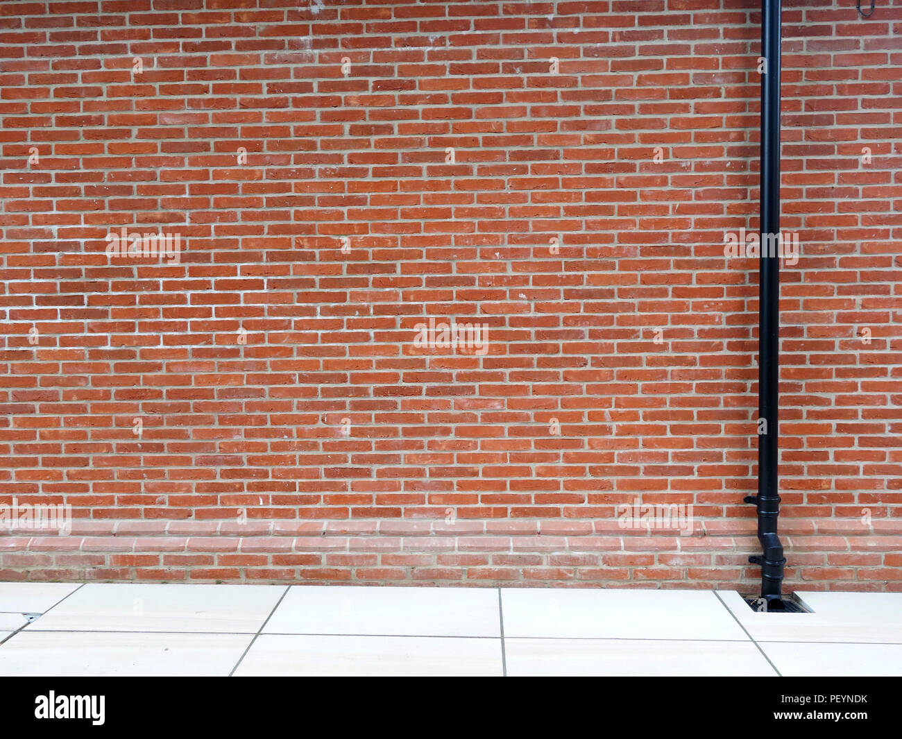 Newly built plain brick wall using reclaimed bricks at large country