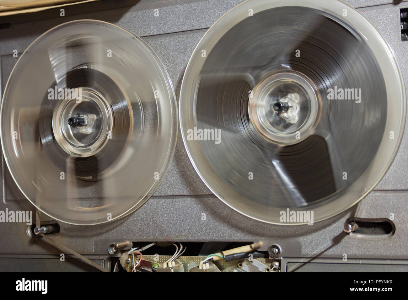 Old reel-to-reel recorder with magnetic tape on it Stock Photo - Alamy