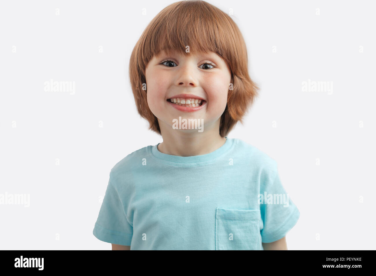 Pretty Red Haired Kid Showing His White Teeth To The Camera