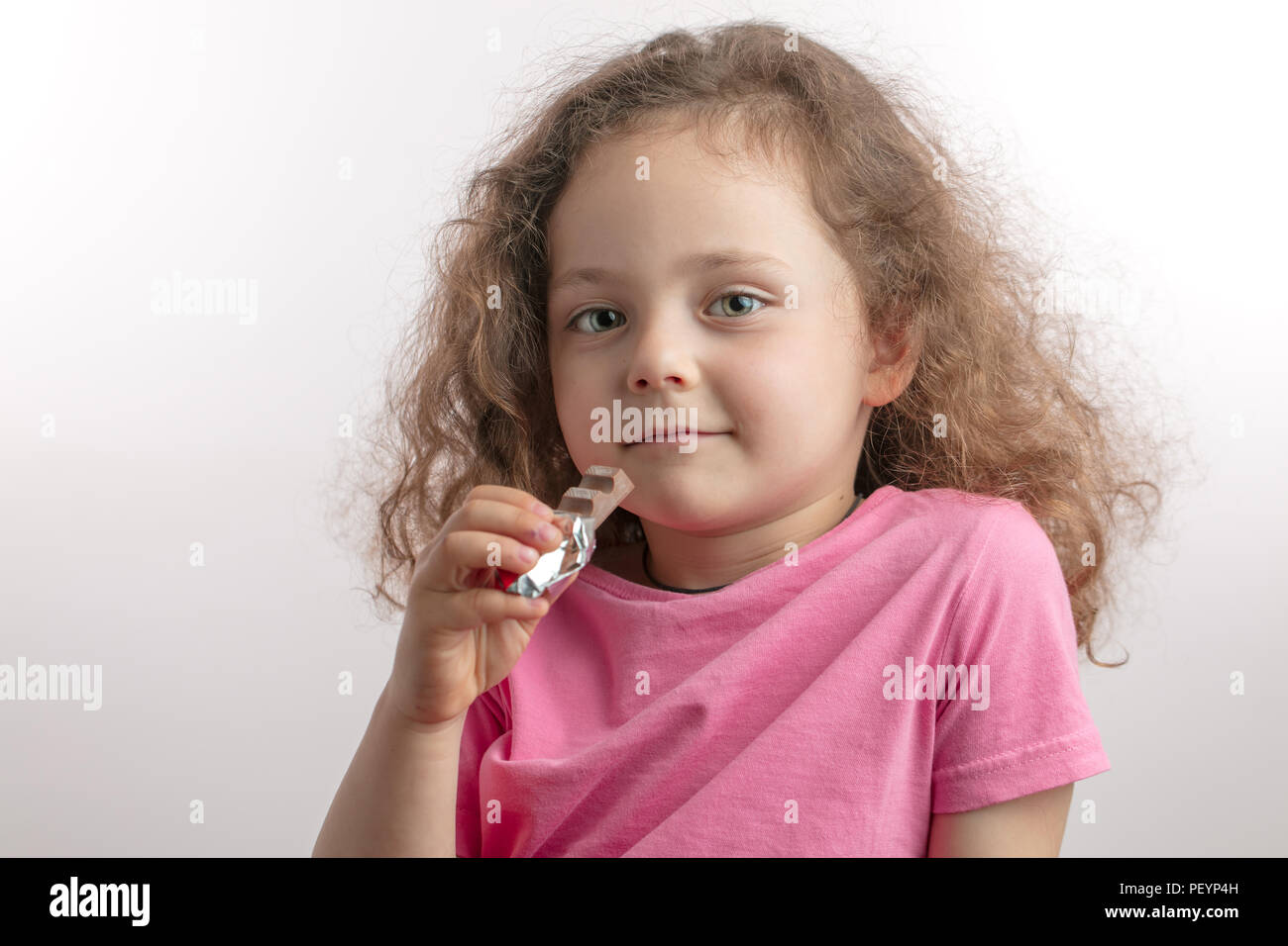 Little girl eating chocolate bar hi-res stock photography and images ...