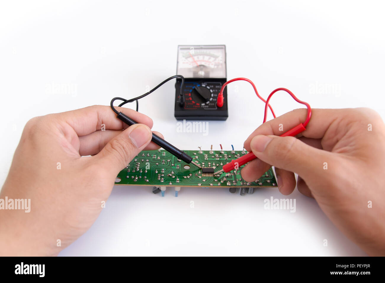 Technician hand with multimeter probes repairing circuit board Stock ...