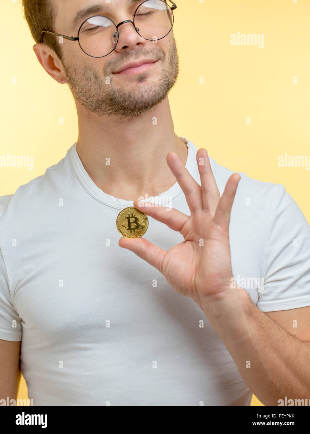 magician with closed eyes is performing a trick with coin. close up ...