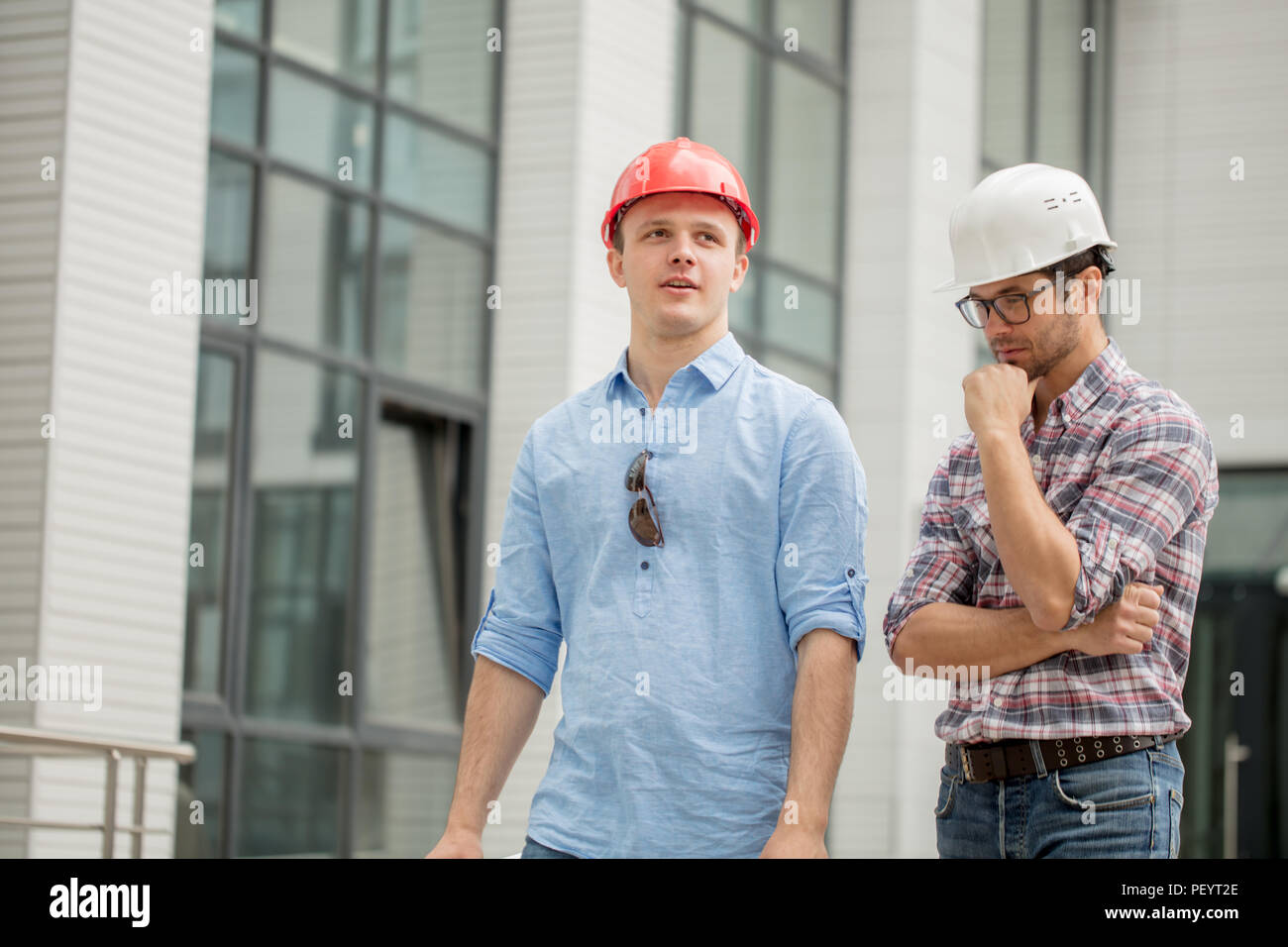 engineer is deliberating a matter while his partner is waiting the answer. close up photo. difficul choise Stock Photo