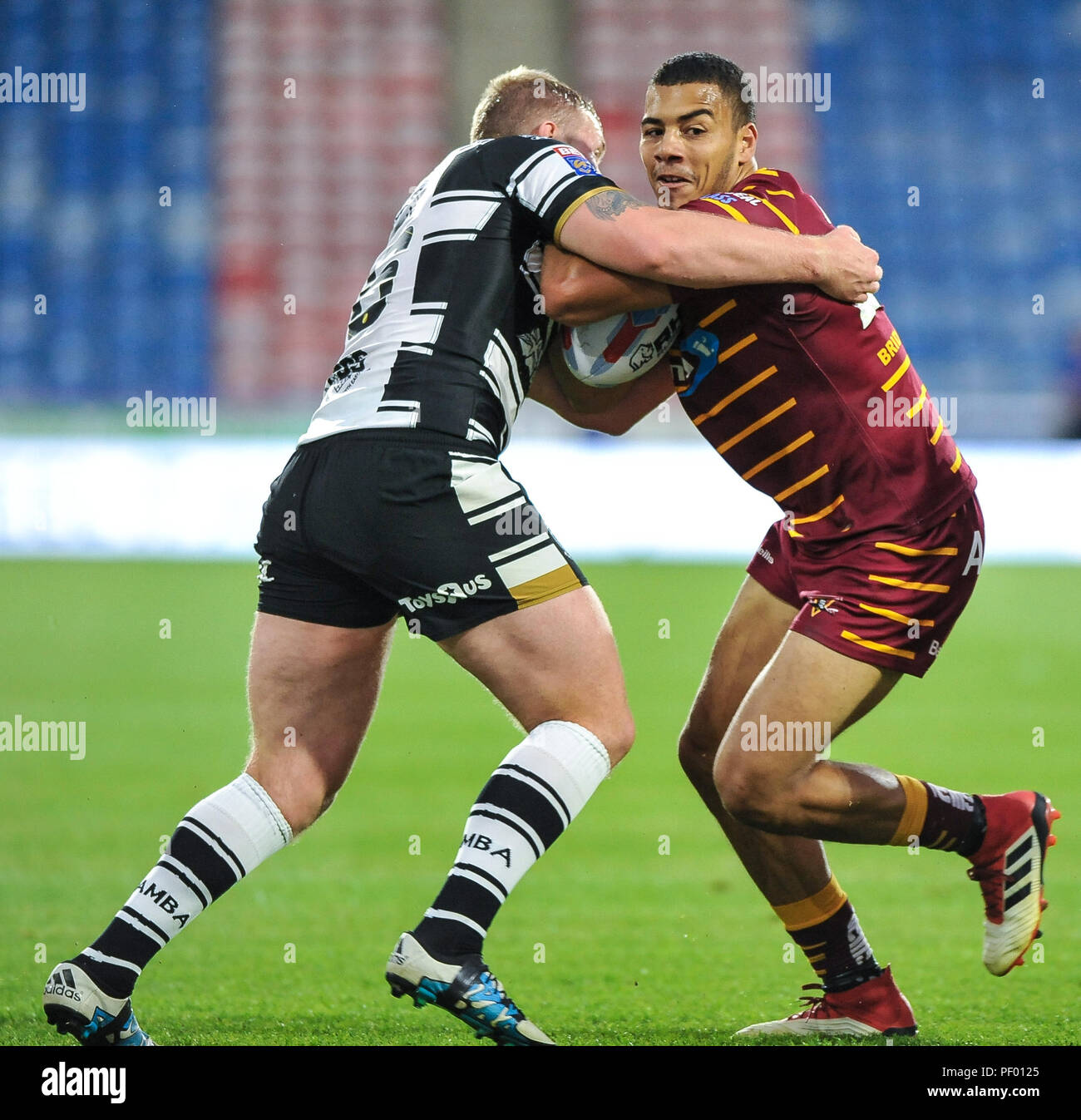 Huddersfield, UK. 17th August 2018. Rugby League Super 8's match between Huddersfield Giants vs Hull FC. ; Darnell Macintosh of Huddersfield Giants is stopped by Hull FC's Fetuli Talanoa at the John Smiths Stadium, Huddersfield, UK. Dean Williams Credit: Dean Williams/Alamy Live News Credit: Dean Williams/Alamy Live News Stock Photo