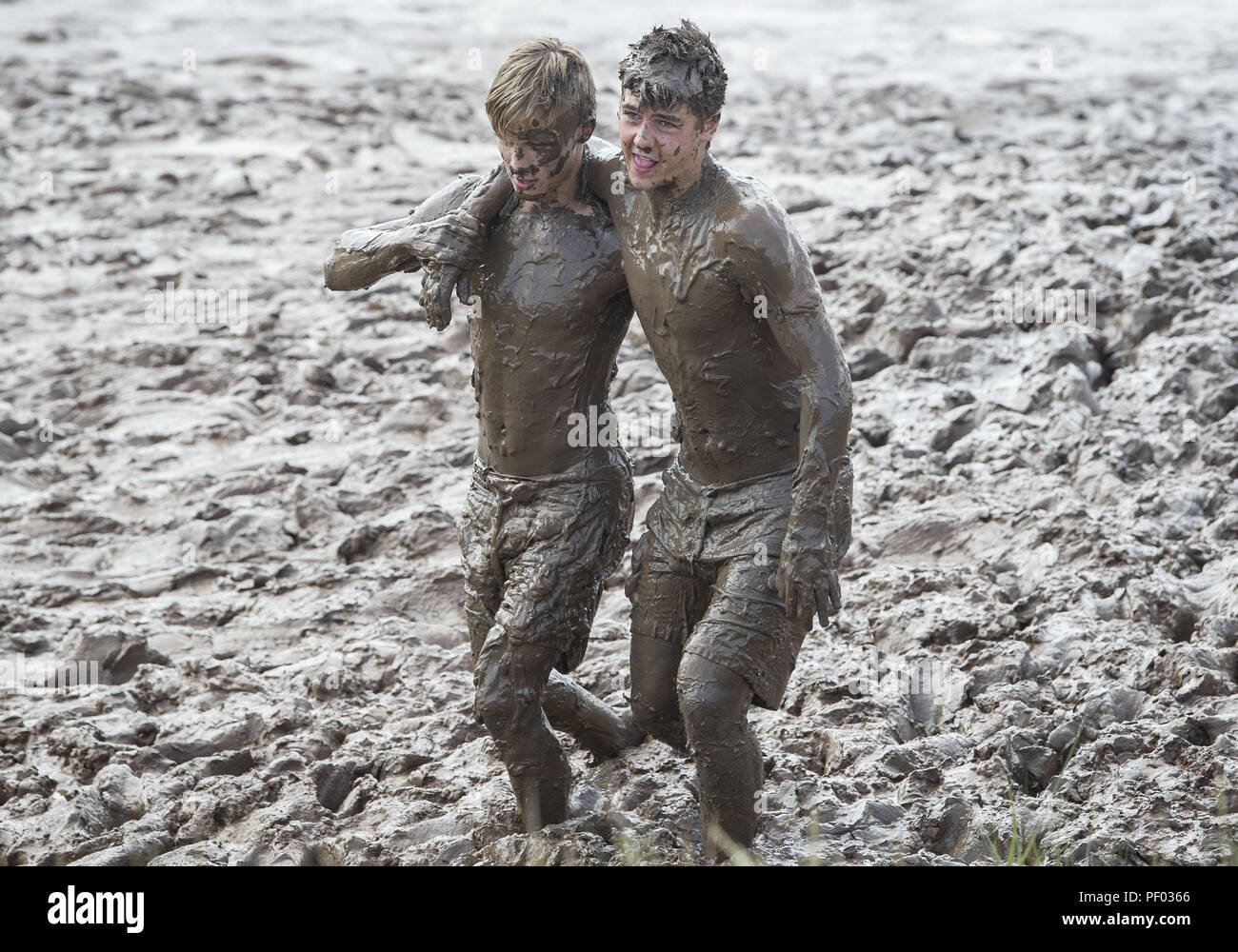 Wolfville, Nova Scotia, Canada. 17th Aug, 2018. Members of the Rugby Ontario (Canada) rugby team wallow in the mud at the Minas Basin between matches. The U16 team was in Wolfville for the Eastern Canadian Rugby Championships, which featured more than 35 teams from throughout Canada. Credit: PJ Heller/ZUMA Wire/Alamy Live News Stock Photo