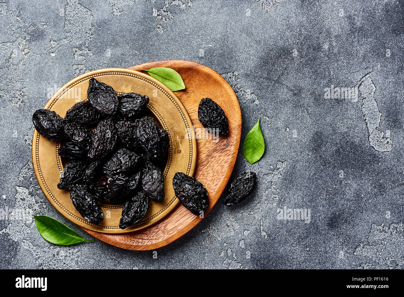 Dried prunes on plate. Top view of peeled plums. Top view. Stock Photo