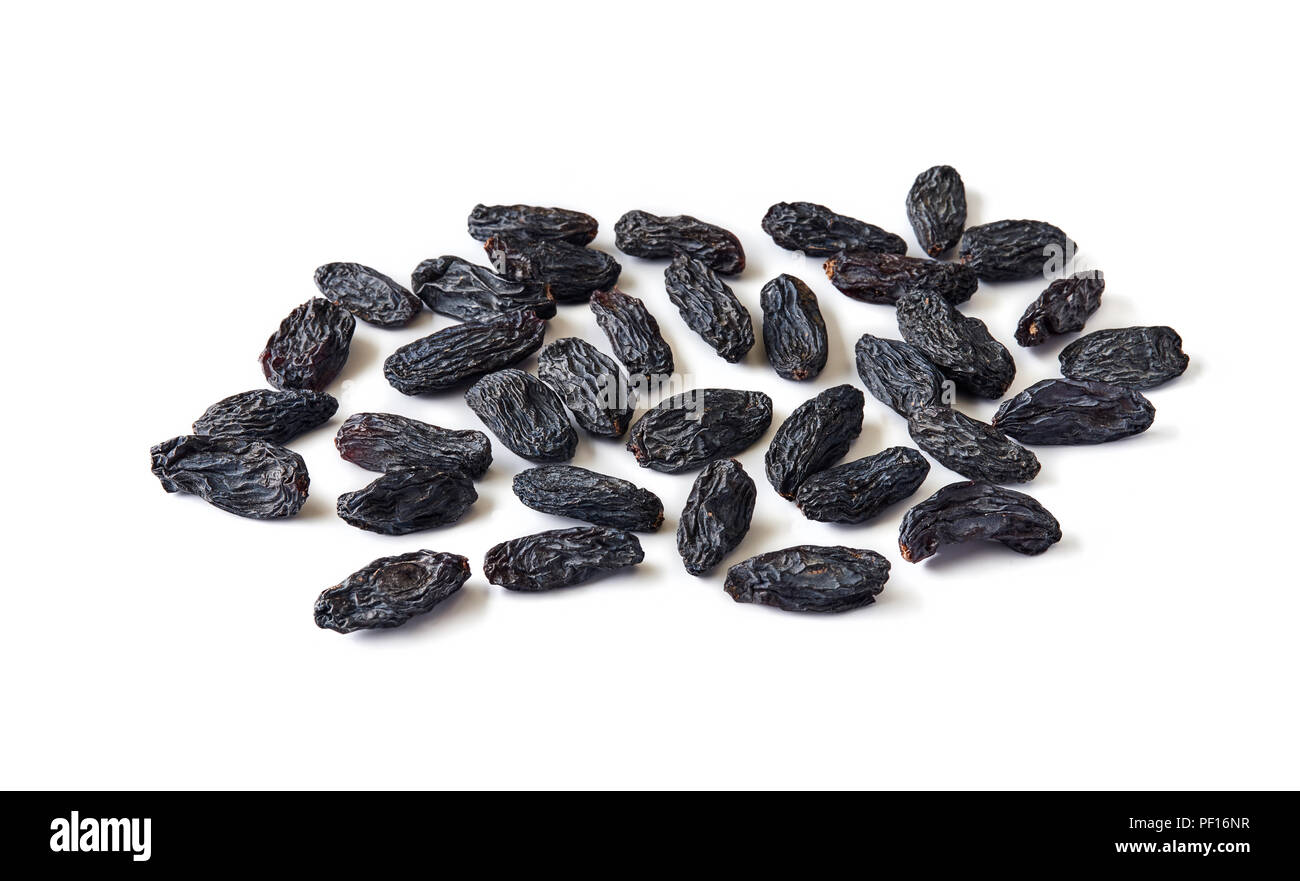 Heap of black raisins isolated on white background. Stock Photo