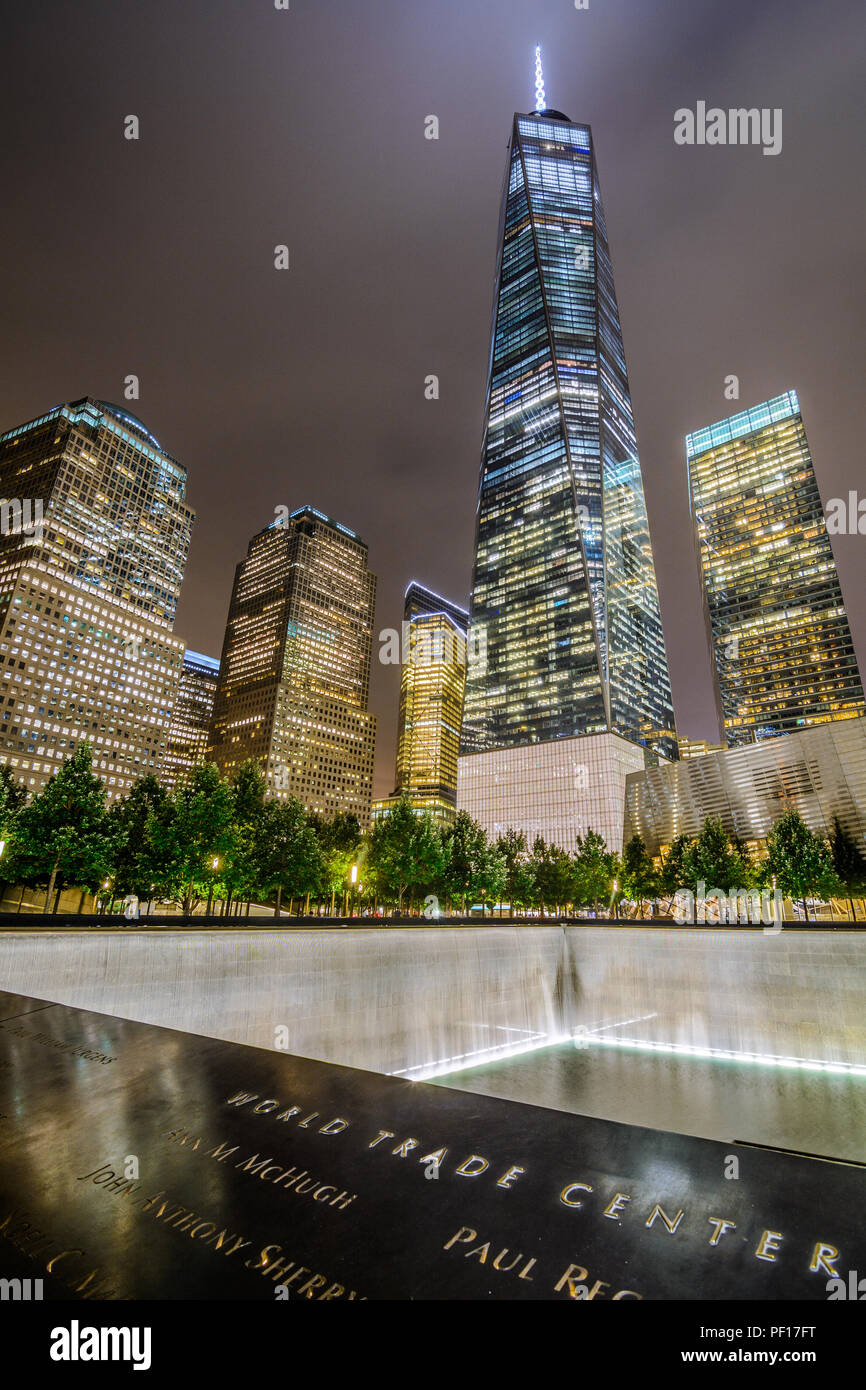 One WTC shines brightly in the background of the 9/11 Memorial in Lower Manhttan, New York City. Stock Photo
