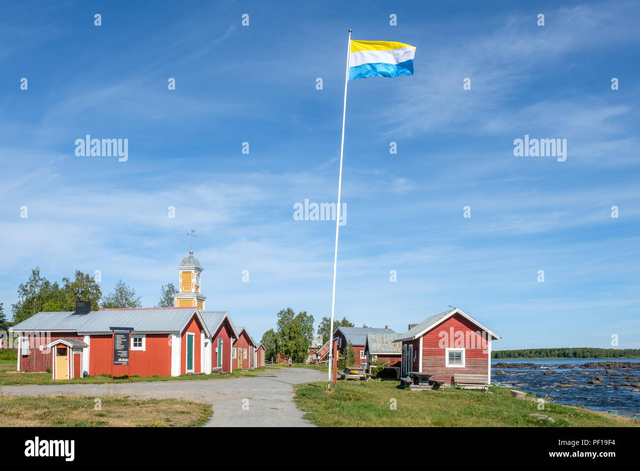 Fishermans cottages and Torne valley flag on the Swedish side of Torne river. Stock Photo