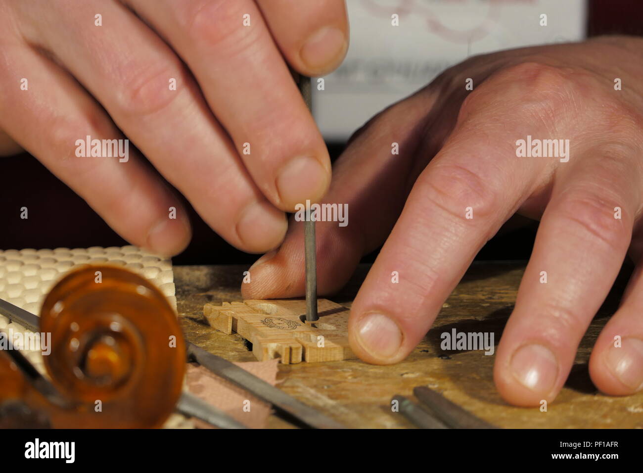 Closeup of violin maker at work in Milano, Italy Stock Photo