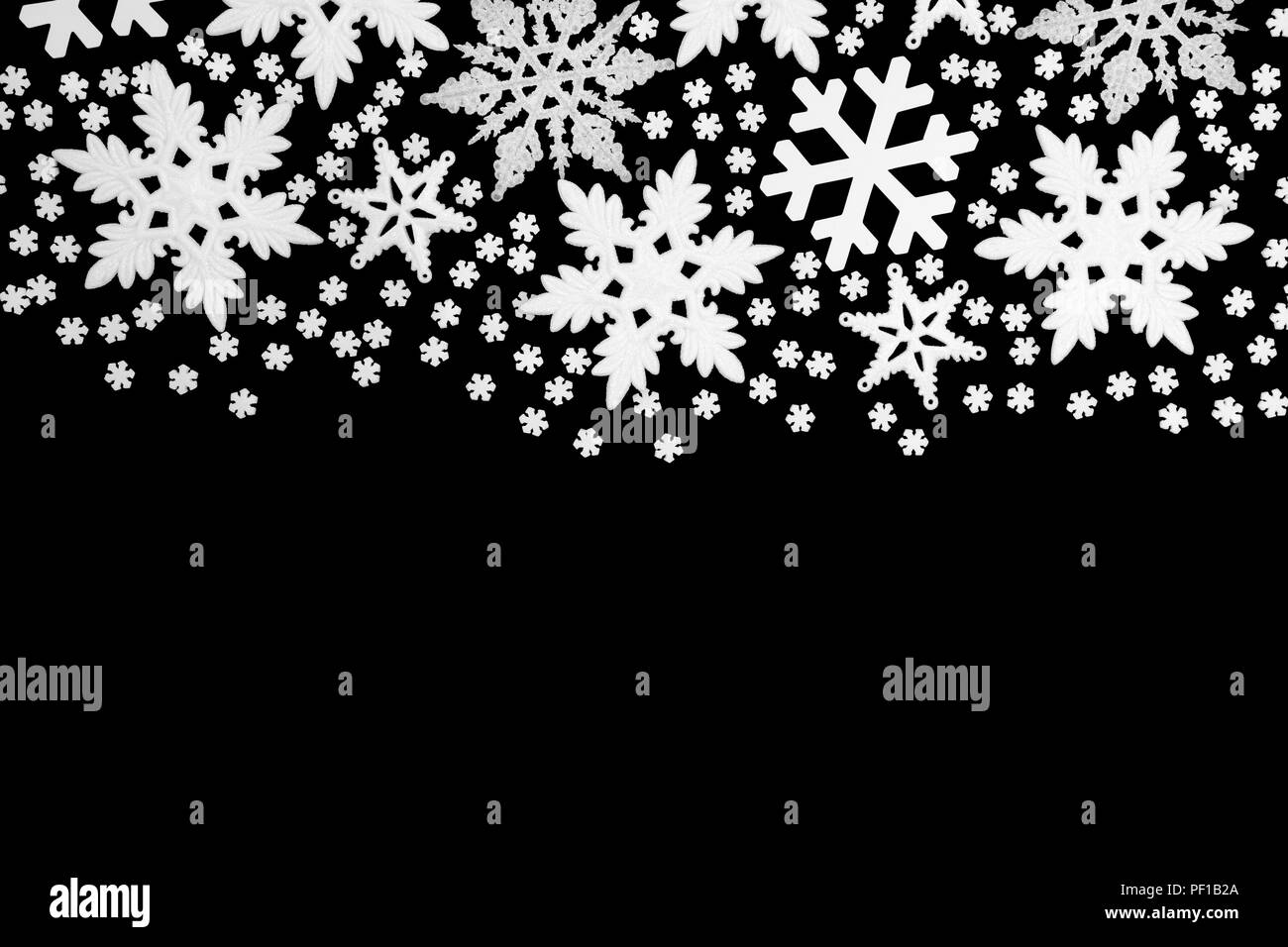 Snowflake christmas and winter abstract background border on black with copy space. Stock Photo