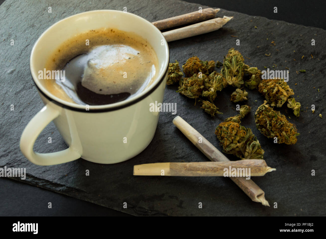 Delicious cup of coffee, a pile of high quality marijuana buds with