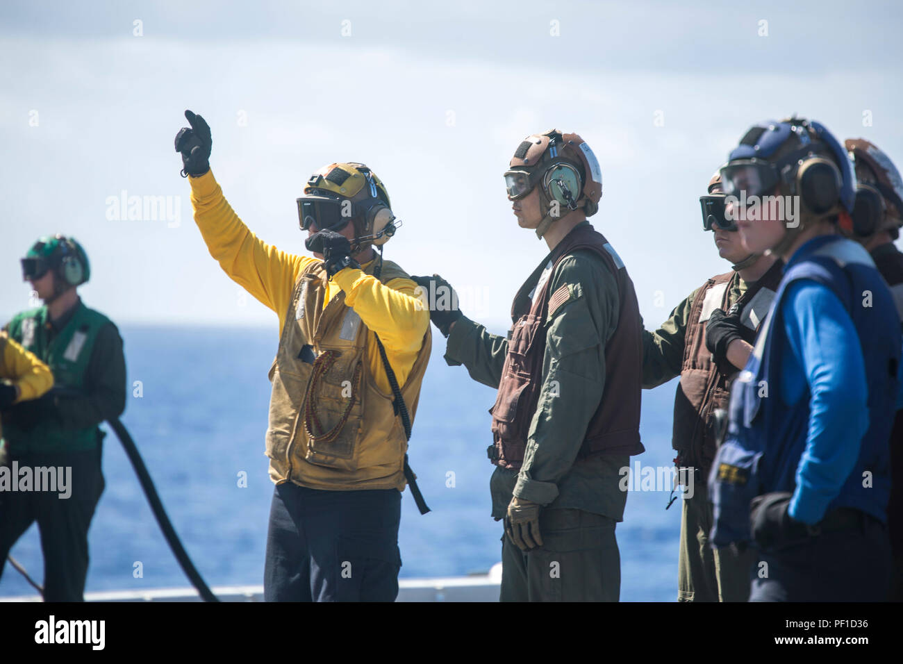 U.S. Marines and Sailors with the Boxer Amphibious Ready Group and 13th Marine Expeditionary Unit conduct aircraft fire hazard drills aboard the USS Boxer, Feb. 24, 2016. More than 4,500 Sailors and Marines from the Boxer ARG, 13th MEU team are currently transiting the Pacific Ocean toward the U.S. 7th Fleet area of operations during a scheduled deployment. (U.S. Marine Corps photo by Sgt. Briauna Birl/RELEASED) Stock Photo