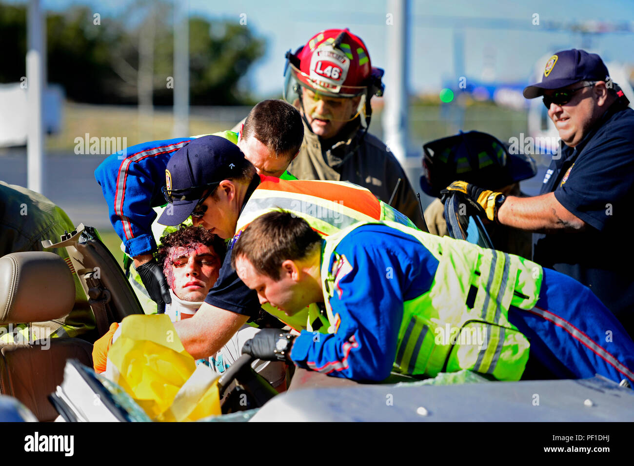 A Johnson High School student, acting as a drunk driving victim, receives medical treatment during a simulated car crash during the Johnson HS Shattered Dreams event, San Antonio, Feb. 17, 2016. Shattered Dreams is an educational program designed to prevent problems resulting from drinking while driving. Fellow students portray the victims and visually engage their peers to consider the gravity of the issue, and promote responsible decision making. Volunteers from Joint Base San Antonio-Lackland, Wilford Hall Ambulatory Services Center and local first-responders also participated in the event. Stock Photo