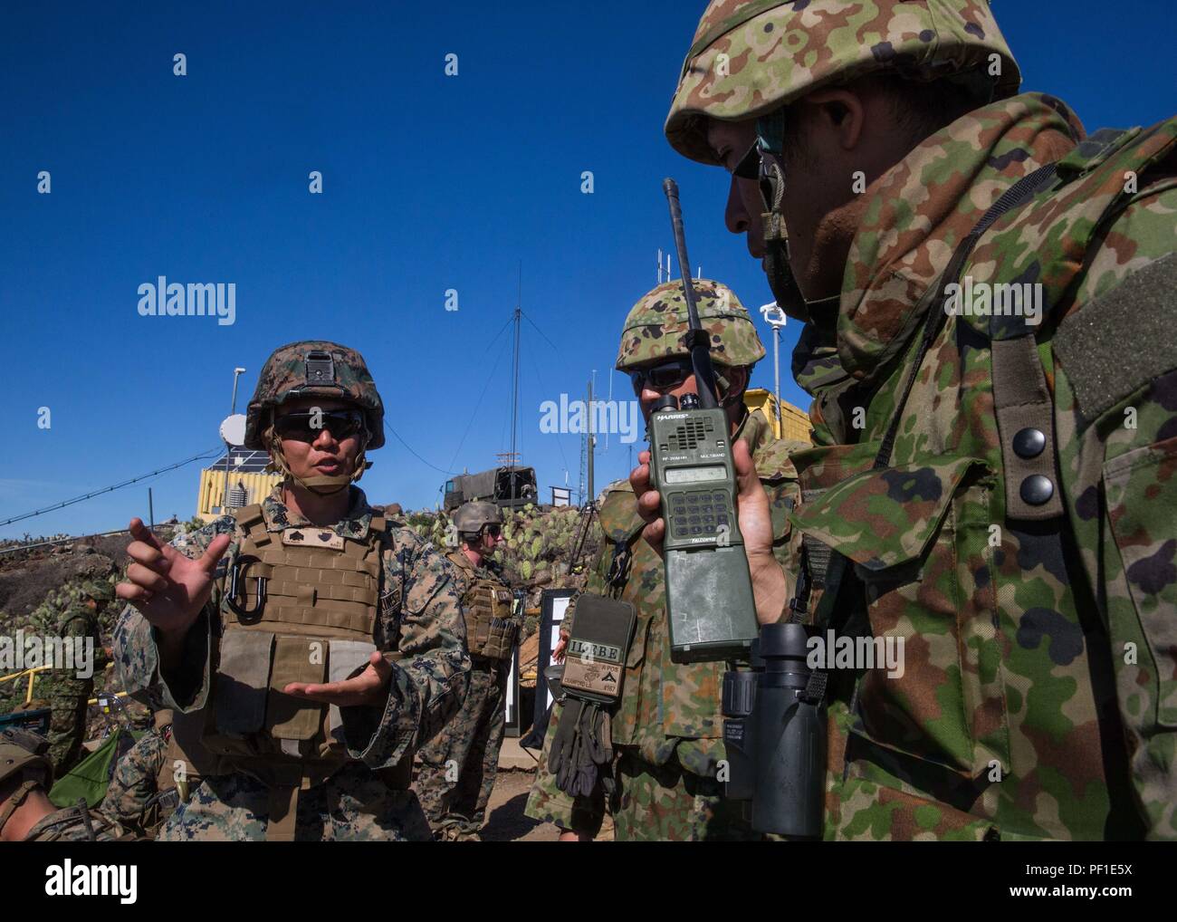 A U.S. Marine Corps interpreter attached to 1st Air Naval Gunfire Liaison Company translates radio messages for a soldier with Western Army Infantry Regiment, Japan Ground Self-Defense Force, during a supporting arms coordination center exercise, (SACCEX), on San Clemente Island, Feb. 22, 2016, as part of Exercise Iron Fist 2016. SACCEX  serves as a cooperative learning tool for the US-Japan partnership through the operation of a SACC, which has developed the USMC and JGSDF’s ability to intergrate naval gunfire, mortars and close-air support  as a combined force. (U.S. Marine Corps photo by La Stock Photo