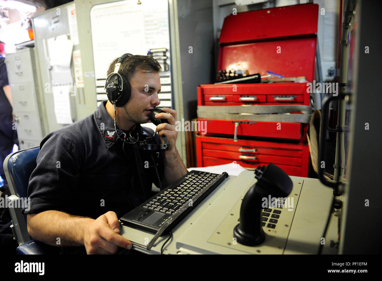 160226-N-VD165-061 PACIFIC OCEAN (Feb. 26, 2016) Fire Controlman 3rd Class Carmen Morganti communicates with a remote control station operator in the combat information center prior to a phalanx close-in weapons system live-fire exercise aboard amphibious assault ship USS Boxer (LHD 4). More than 4,500 Sailors and Marines from Boxer Amphibious Ready Group, 13th Marine Expeditionary Unit (13th MEU) team are currently transiting the Pacific Ocean toward the U.S 7th Fleet area of operations during a scheduled deployment. (U.S. Navy photo by Mass Communication Specialist 2nd Class Jose Jaen/Releas Stock Photo