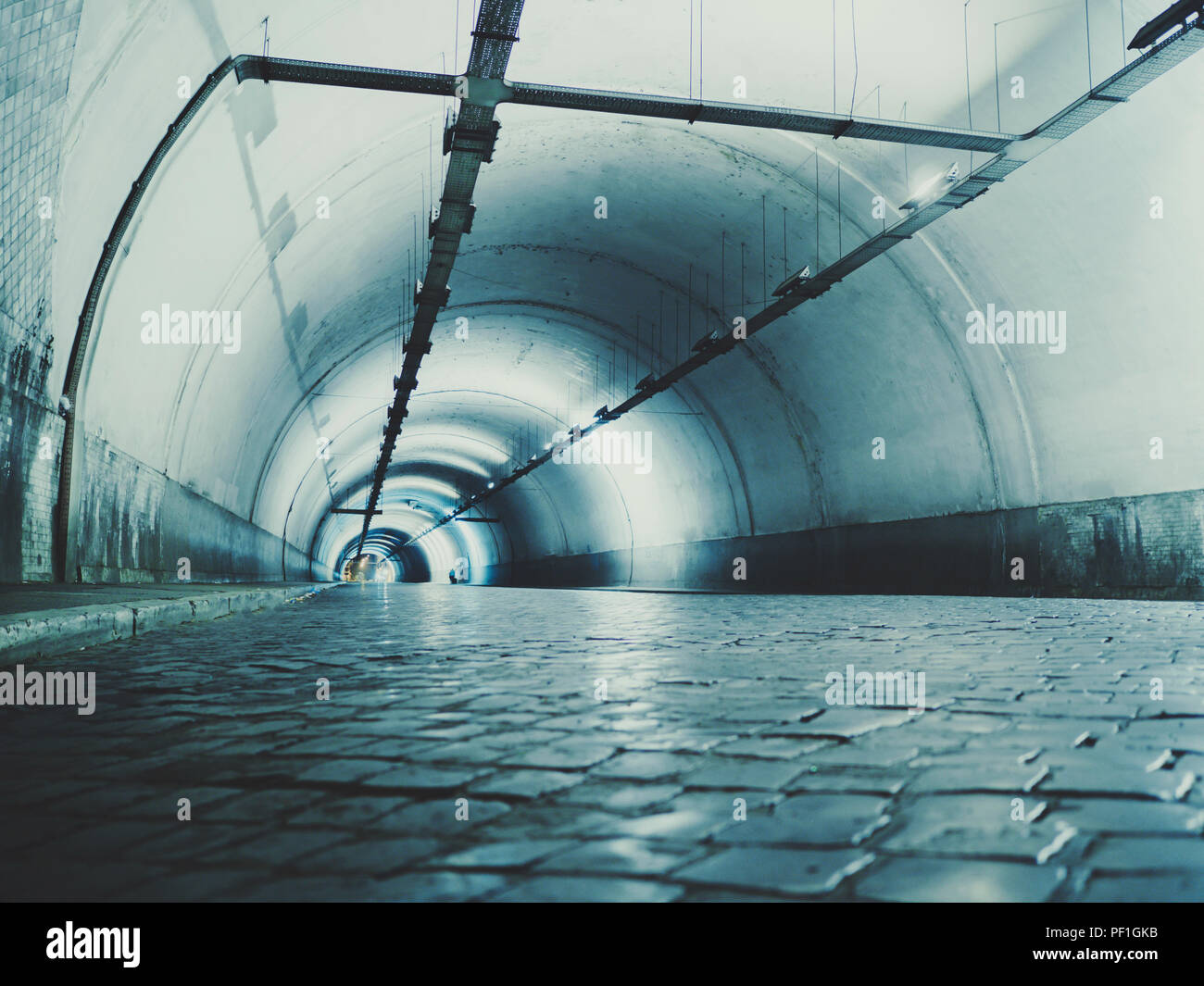 Highway tunnel. Interior of urban tunnel without traffic in nught with