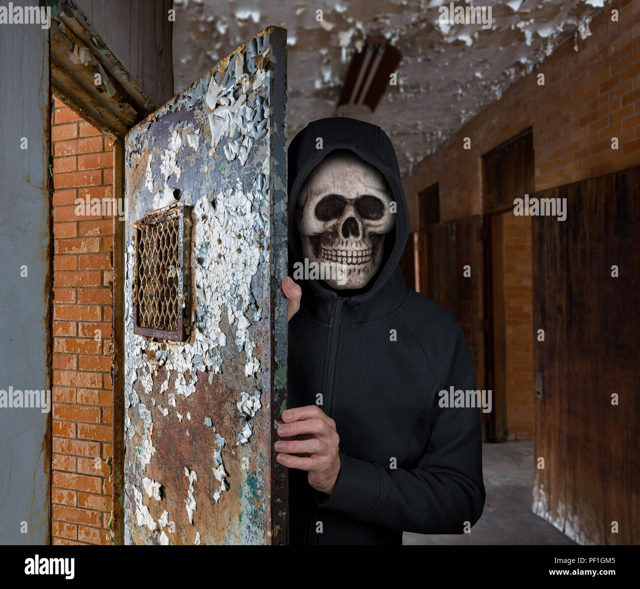Halloween theme of man with skull mask welcoming you to prison Stock Photo