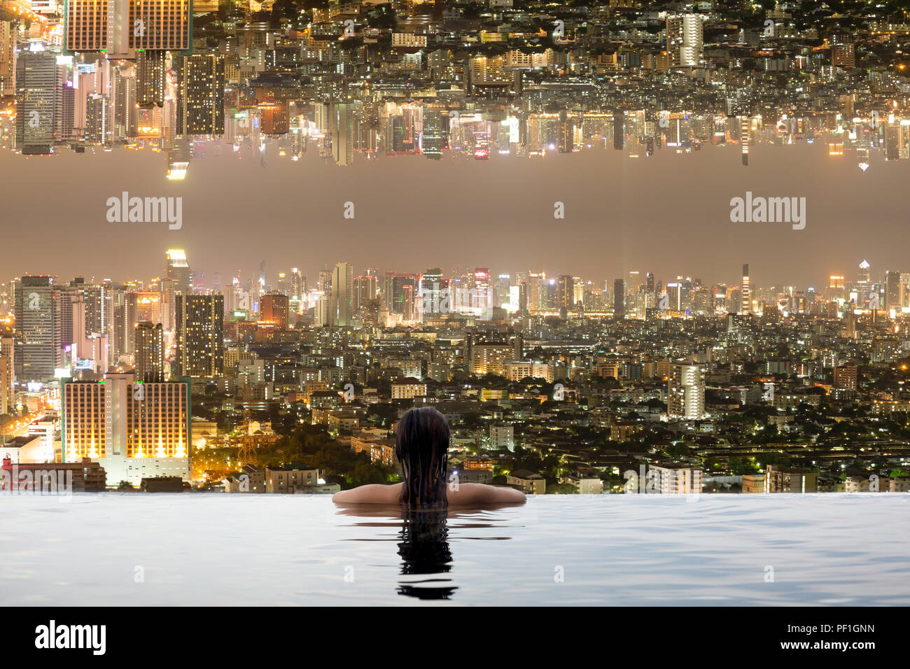 Woman in swimming pool with city upside down Stock Photo - Alamy