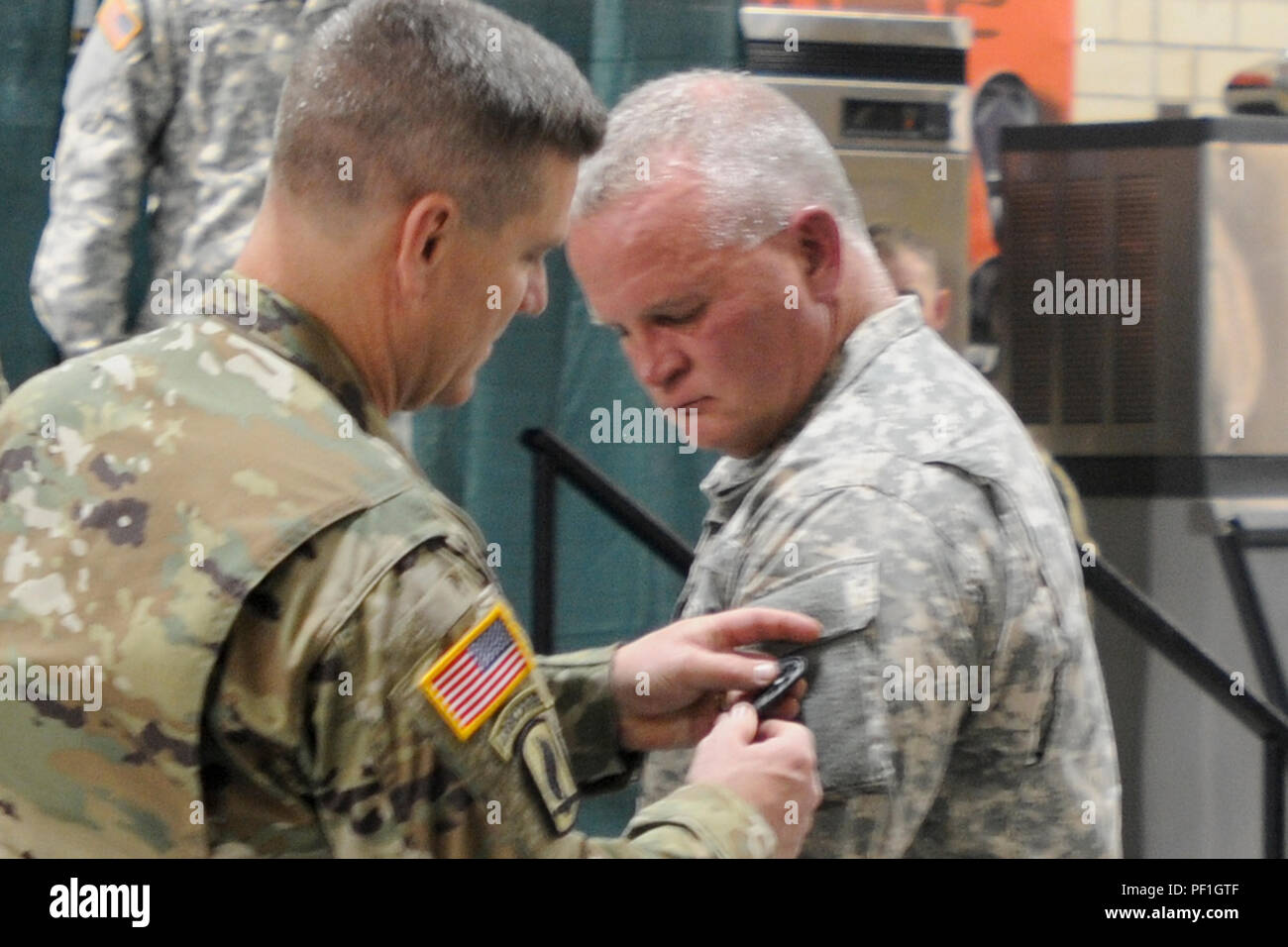 U.S. Army Brig. Gen. Timothy Sheriff, deputy commanding general of the 263rd Army Air and Missile Defense Command, South Carolina National Guard looks on as U.S Army Col. Frank Rice, commander of the 678th Air Defense Brigade, South Carolina National Guard places the new unit patch on the shoulder of Command Sgt. Maj. Russell Vickery, brigade command sergeant major of the 678th during an activation ceremony for the unit in Eastover, S.C., February 20, 2016.  The ceremony included an uncasing of the guidon marking the definitive point in time to commemorate the beginning of the unit’s history.  Stock Photo