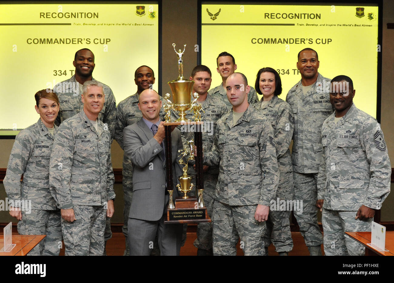 Jake Regal, Keesler sports director, presents the commander’s trophy to the 334th Training Squadron at Stennis Hall Feb. 24, 2016, Keesler Air Force Base, Miss. The competition is centered around points awarded to a squadron based on their participation in the intramural sports program and special events facilitated by the base fitness centers. This is the 6th consecutive year the “Gators” have earned the trophy. (U.S. Air Force photo by Kemberly Groue) Stock Photo