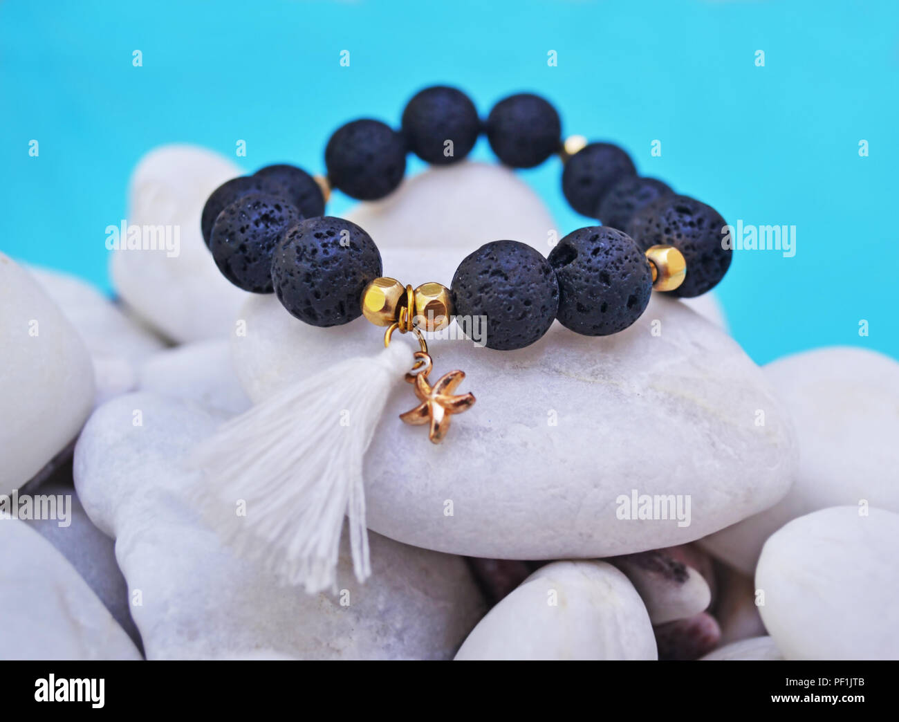gemstone bracelet with black Lava beads and pendant starfish - volcano stones - semi precious stones jewelry Stock Photo