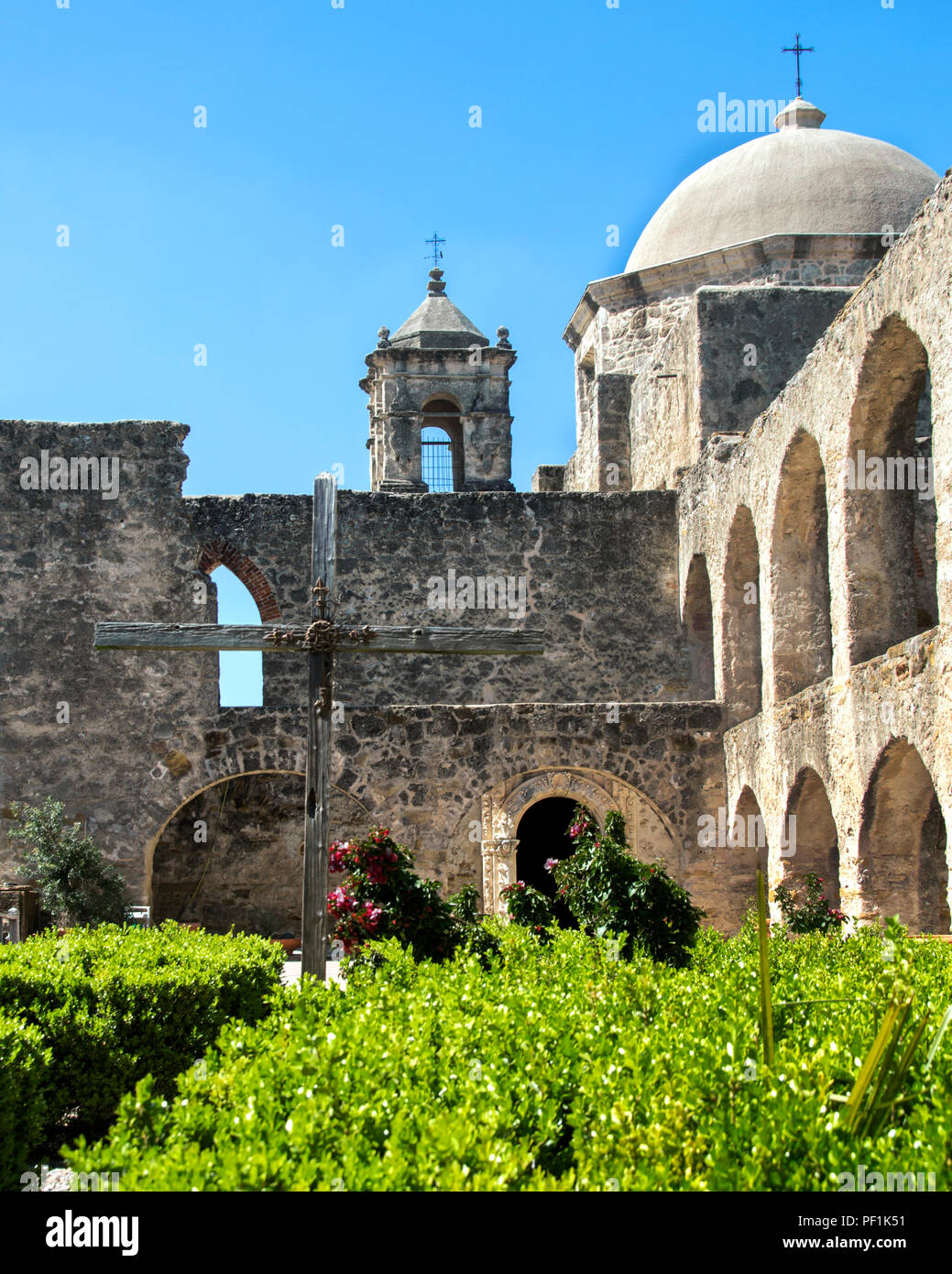 Mission San Jose San Antonio Texas View of the mission complex with bell tower, arched walls, cross, and chapel dome from the Convento. Stock Photo