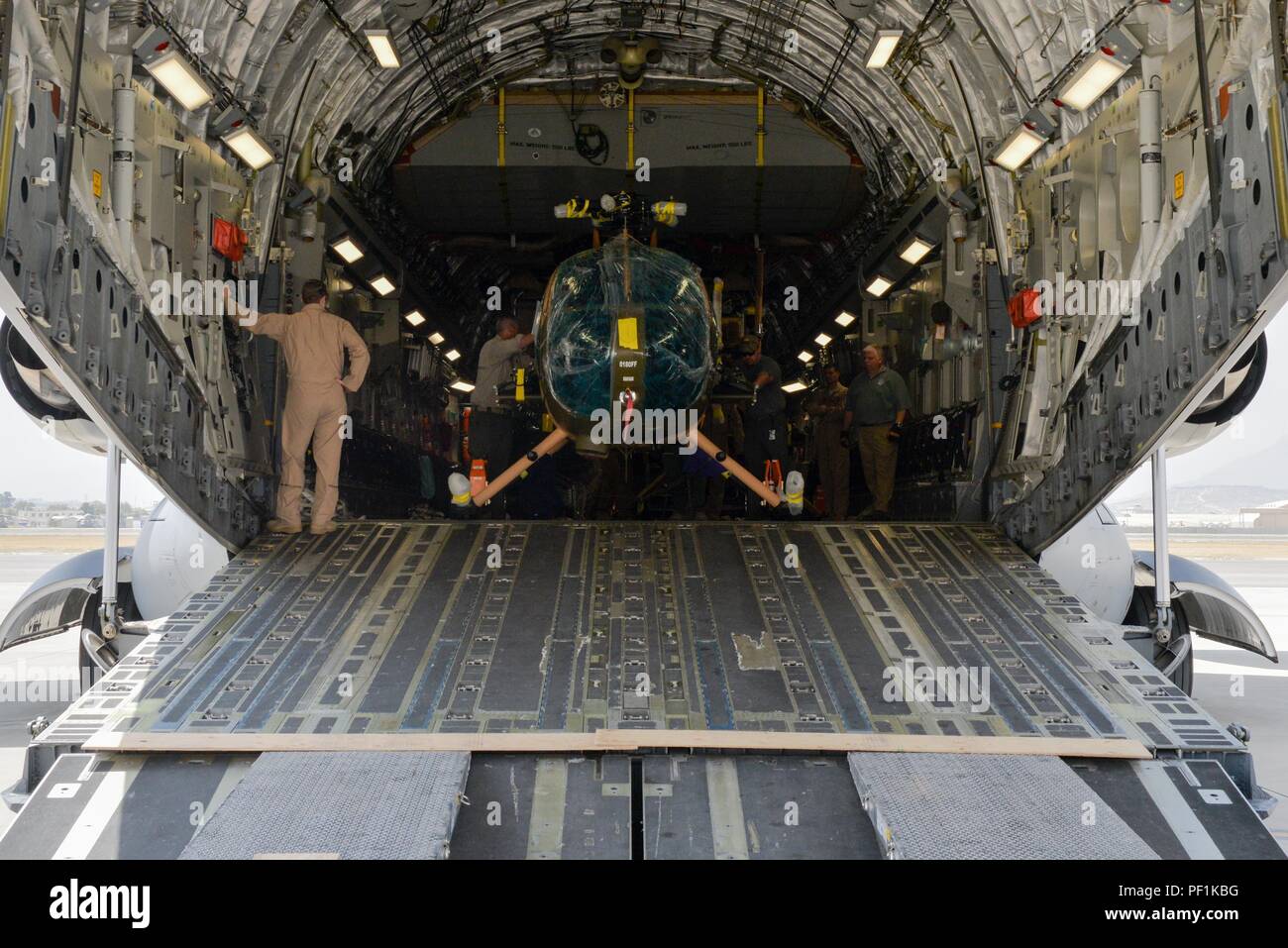 Four new MD-530 Cayuse Warrior helicopters arrived at Hamid Karzai International Airport, Afghanistan, Aug. 25, 2016, via a C-17 Globemaster III. The four helicopters, scheduled to be the final four delivered to the Afghan air force, brings the AAF total number of MD-530s to 27. (U.S. Air Force photo by Tech. Sgt. Christopher Holmes) Stock Photo