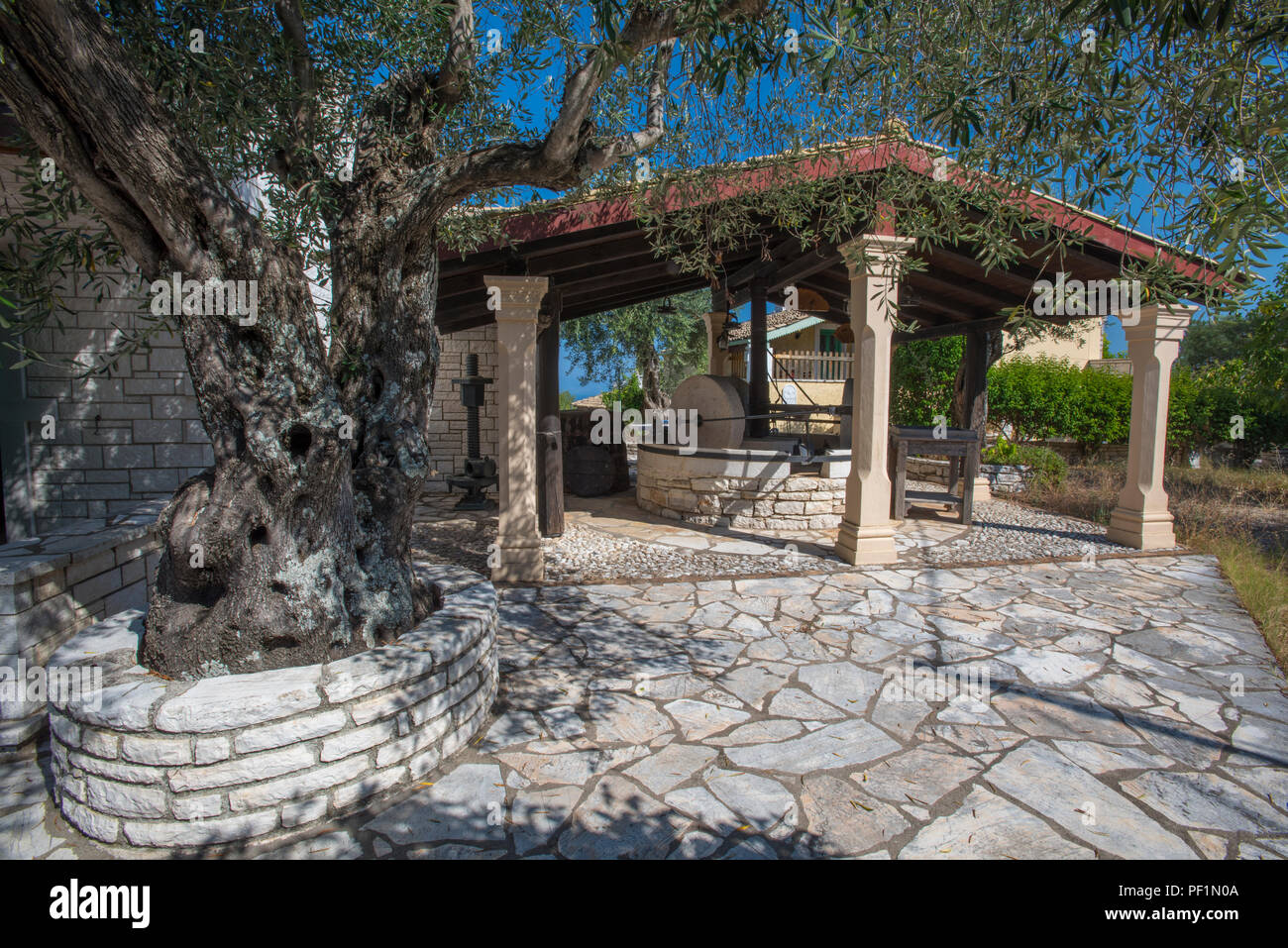 an old olive press and sun shelter at an old villa thea at kassiopi on the greek island of corfu in Greece. Stock Photo