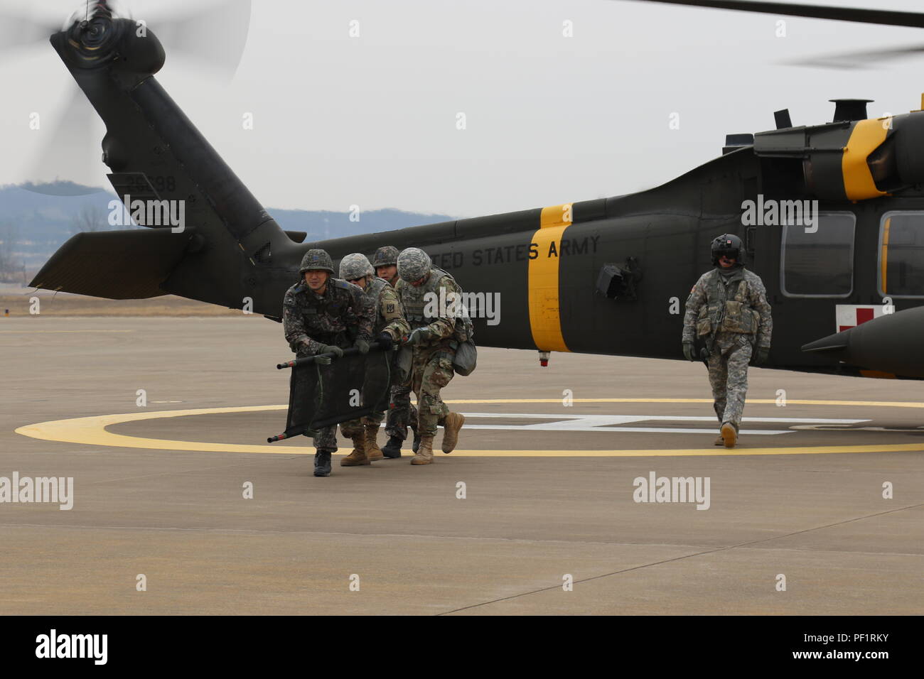A medic team disengages the UH-60 Black Hawk where they just loaded a ...