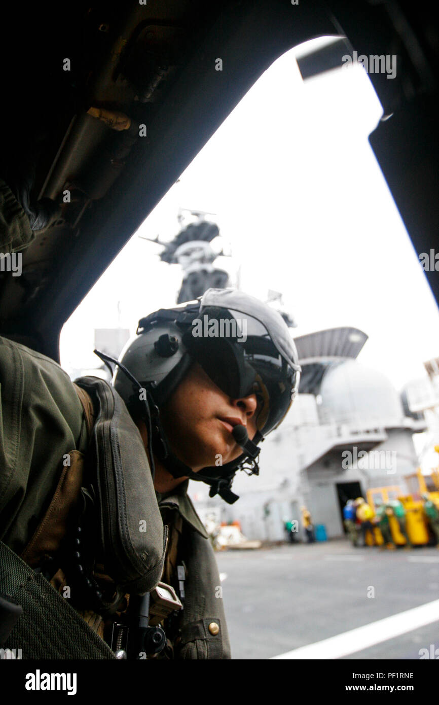Sgt. Nicholas Attikai leans out of an MV-22B Osprey belonging to Marine Medium Tiltrotor Squadron 265 (Reinforced), 31st Marine Expeditionary Unit, to ensure the aircraft is clear to take off from the deck of the USS Bonhomme Richard (LHD 6), Feb. 12, 2016. Marines and sailors with the 31st MEU flew from the BHR to the Ie Shima Training Facility to conduct a vertical assault as part of amphibious integration training with the ships of the Bonhomme Richard Amphibious Ready Group. Attikai, a native of Tonalea, Arizona, is an Osprey crew chief with VMM-265 (Rein.), 31st MEU. (U.S. Marine Corps ph Stock Photo
