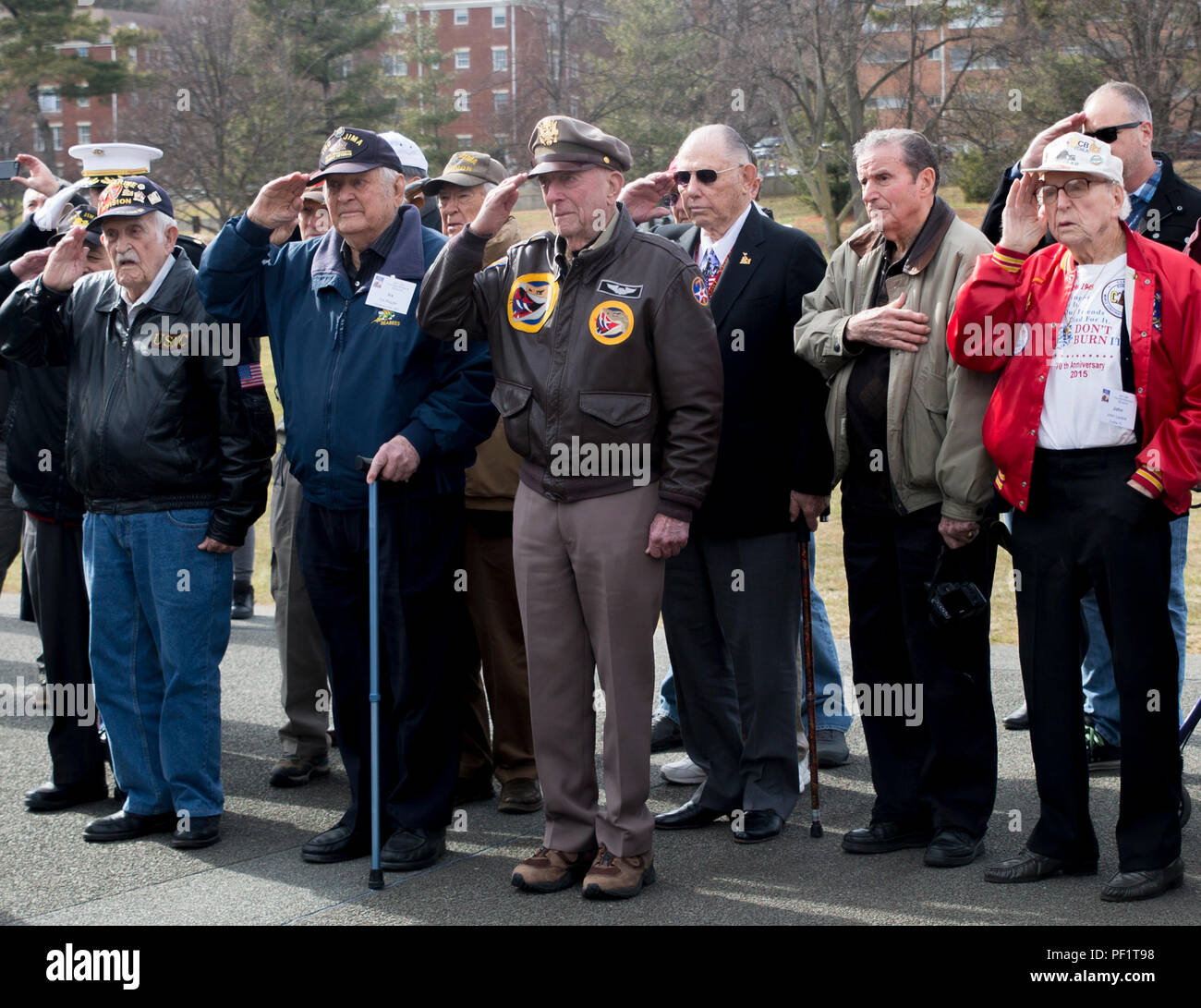 WWII veterans George Cattelona, USMC; Ira Rigger, USN; Jerry Yellin, USA; Gene Bell, USMC; Bud Hampton, USMC; and John Lazere, USN, render honors during a wreath laying ceremony at the Marine Corps War Memorial, Arlington, Va., Feb. 19, 2016. Earlier that morning, a memorial service commemorating the 71st anniversary of the landing on Iwo Jima took place at Crawford Hall, Marine Barracks Washington, D.C. Iwo survivors, family and friends traveled to the National Capitol Region to take part in the Iwo Jima Association of America’s 71st Anniversary, Reunion and Symposium. (Official Marine Corps  Stock Photo