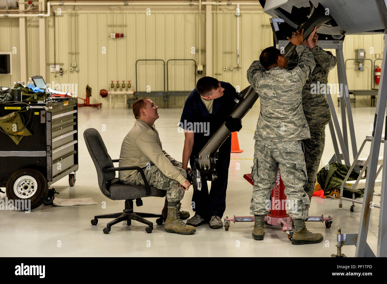 Instructors and Students place landing gear into an aircraft at Creech