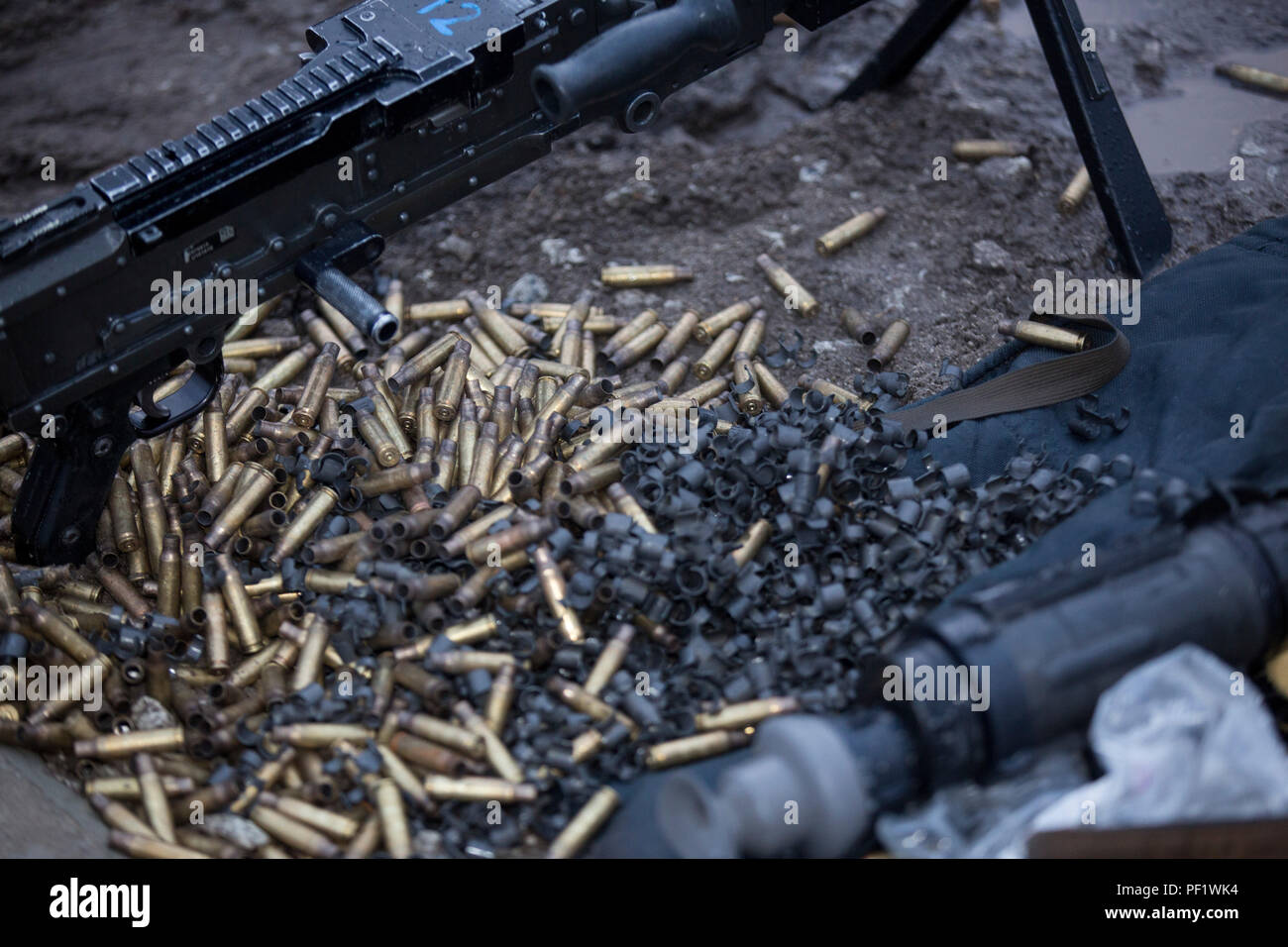 Gunney Shell Spent 7.62 caliber shell casings are seen next to an M-240B machine gun ...