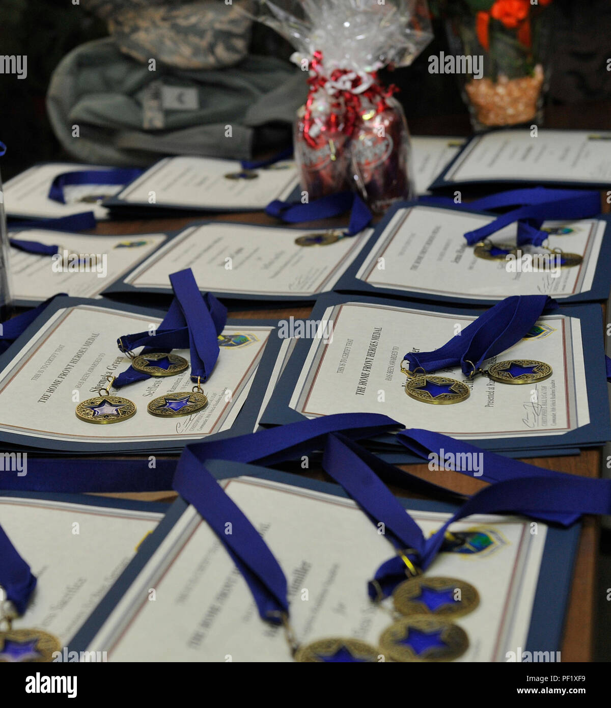 Awards for family members of deployment returnees lay on a table display at a Homefront Heroes ceremony Feb. 19, 2016, at Ramstein Air Base, Germany. The event recognized the sacrifices made by families while deployed members were away. (U.S. Air Force photo/Airman 1st Class Larissa Greatwood) Stock Photo