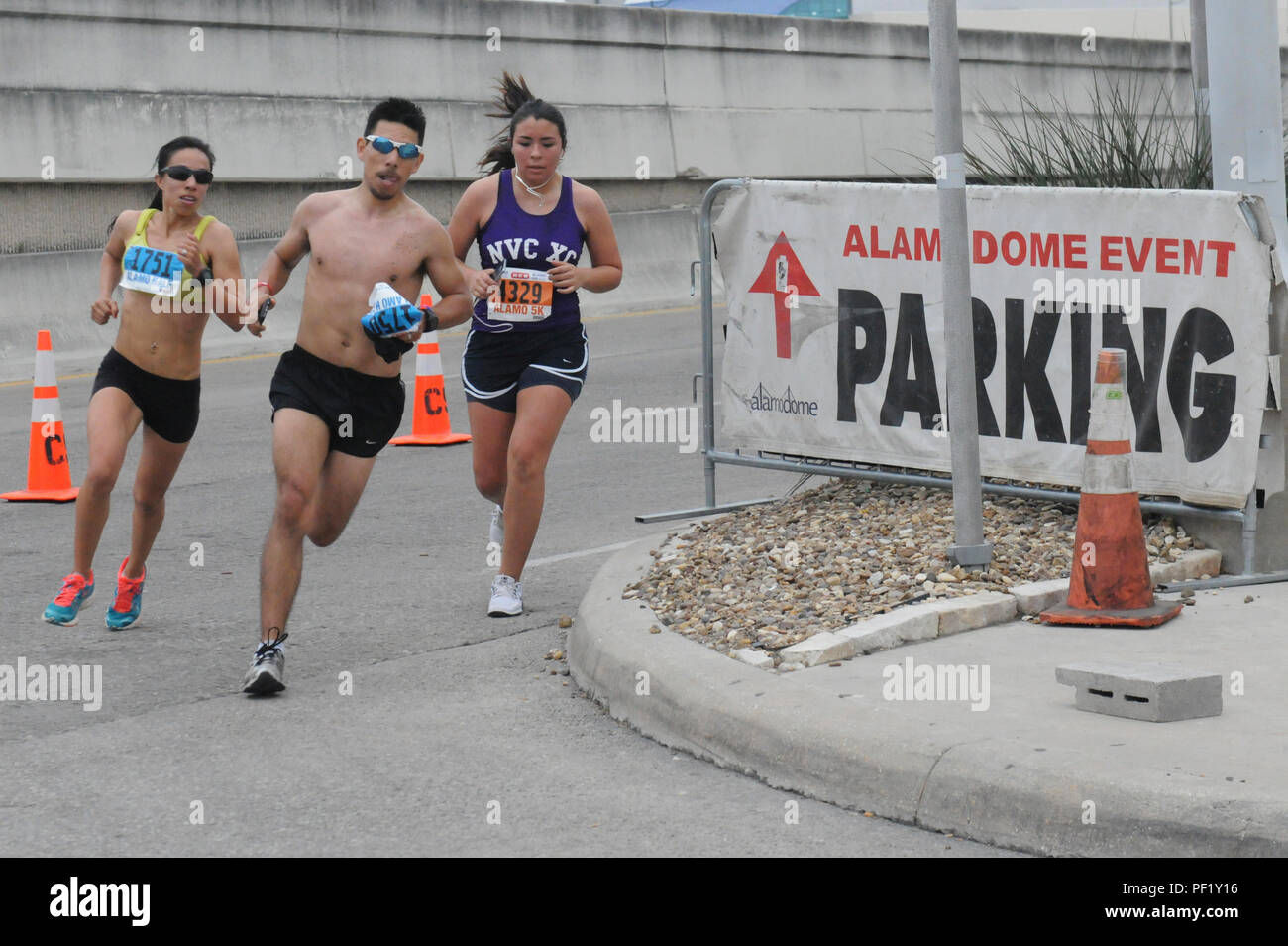 Runners round the corner before entering the Alamo Dome and the finish