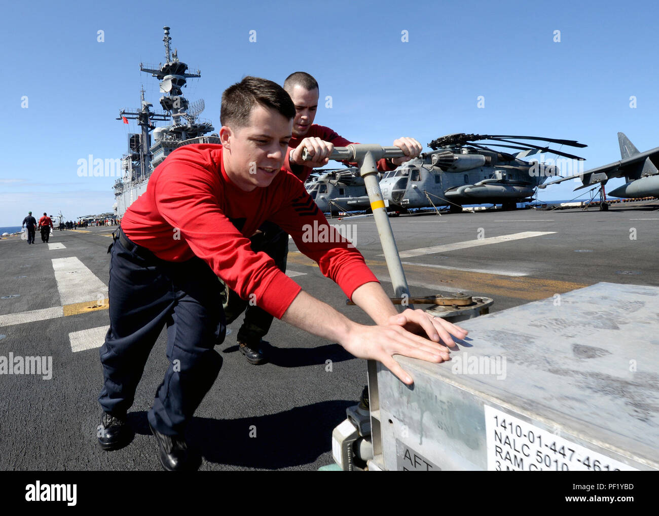 160224-N-GV721-228 PACIFIC OCEAN (Feb. 24, 2016) Aviation Ordnanceman 1st Class Ryan Heeney (left) and Aviation Ordnanceman 1st Class Michael Guidinger transport a guided missile round pack (GMRP) on the flight deck in preparation to load a RIM-116 Rolling Airframe Missile launcher aboard amphibious assault ship USS Boxer (LHD 4). More than 4,500 Sailors and Marines from the Boxer Amphibious Ready Group, 13th Marine Expeditionary Unit (13th MEU) team are currently transiting the Pacific Ocean toward the U.S. 7th Fleet area of operations during a scheduled deployment. (U.S. Navy photo by Mass C Stock Photo