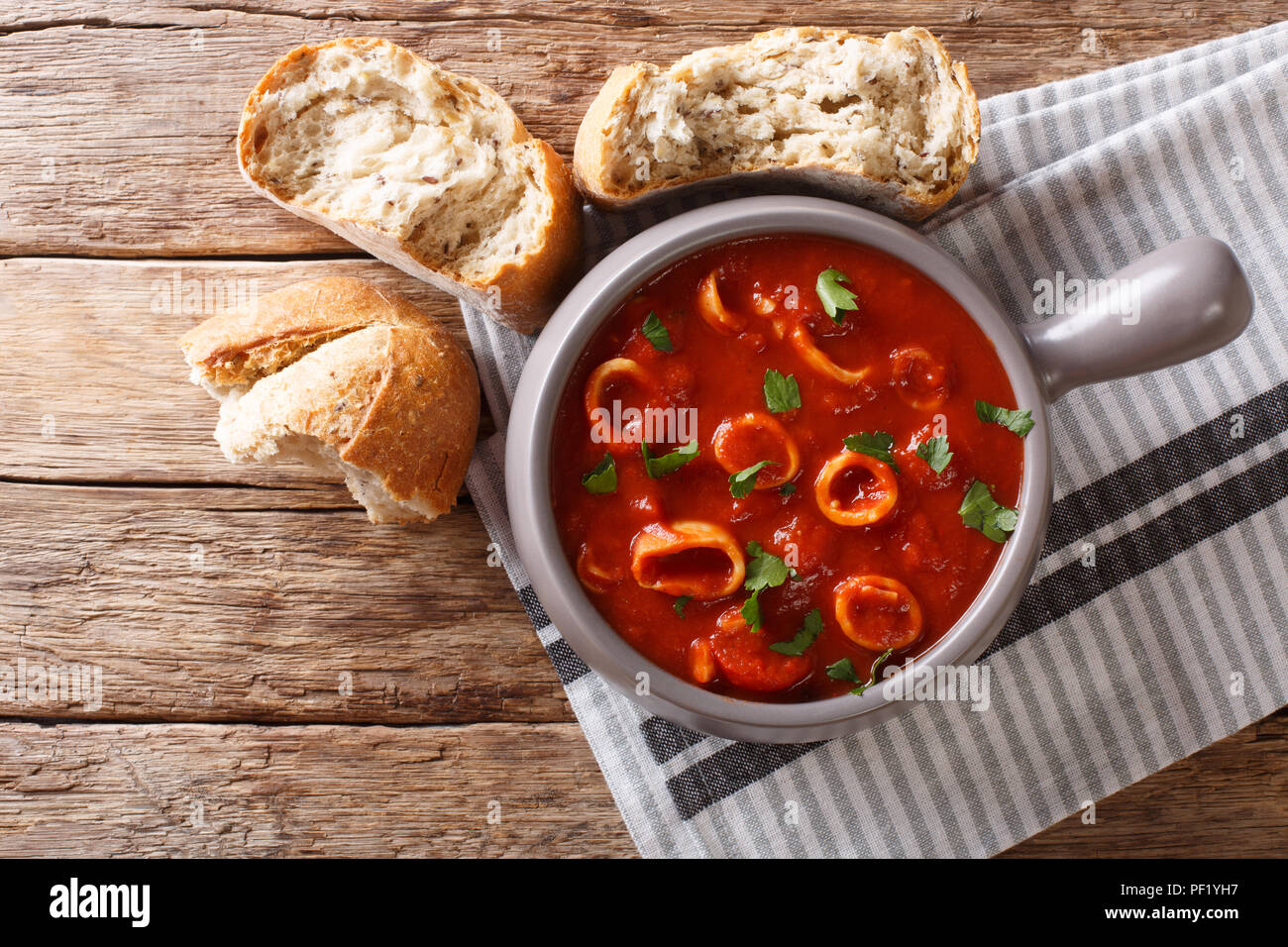 Homemade Italian food braised squid in tomato sauce with spices and
