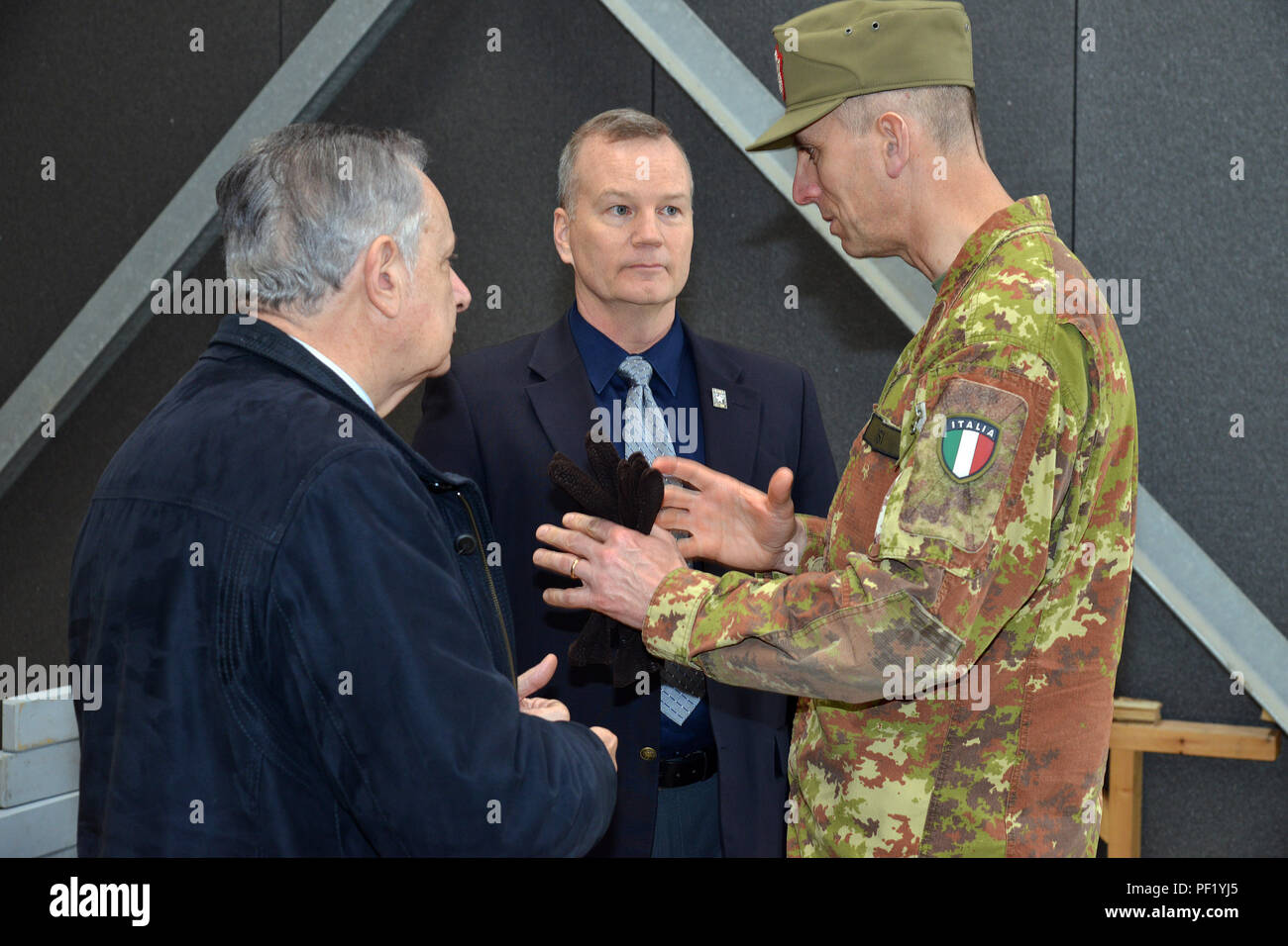 Italian Army Brig. Gen. Michele Risi, Multinational Land Force “Julia” Alpine Brigade Commander (right) speaks with  James V. Matheson, Chief, U.S. Army Regional Training Support Division (center), Ivano Trevisanutto, Chief, U.S. Army Training Support Center Italy (left), tour the RTSD South in Caserma Ederle, Vicenza, Italy, Feb. 24, 2016. Italian Army visit U.S. Army RTSD South, in order to enhance to bilateral relations and to expand levels of cooperation and the capacity of the personnel involved in joint operations. (Photo by Visual Information Specialist Paolo Bovo/Released) Stock Photo